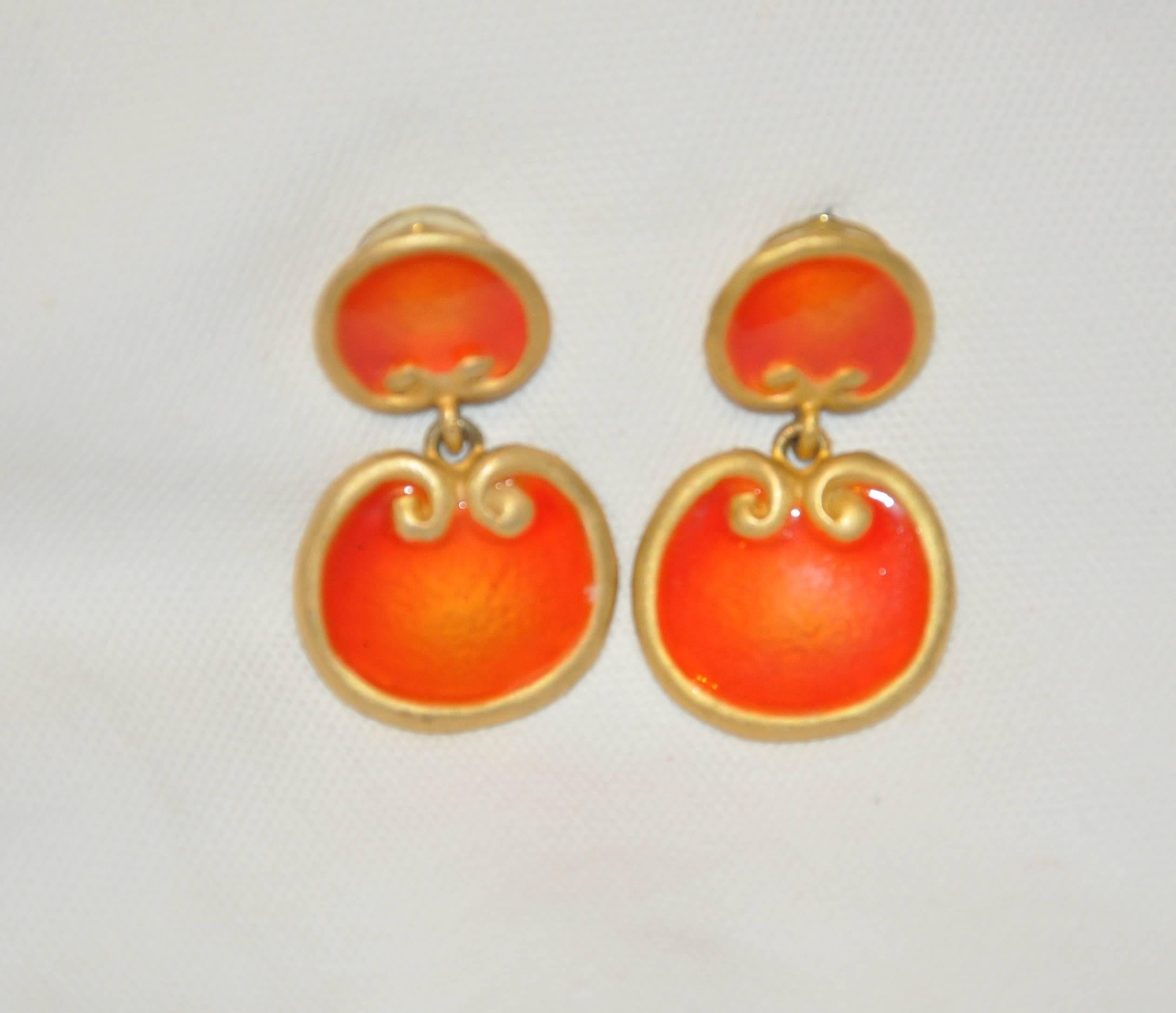       This wonderful whimsical combination of gilded gold vermeil hardware accented with tangerine enamel earrings measures 1 5/8 inches in height, width measures 1 inch, depth is 6/8 inch. Made in Us