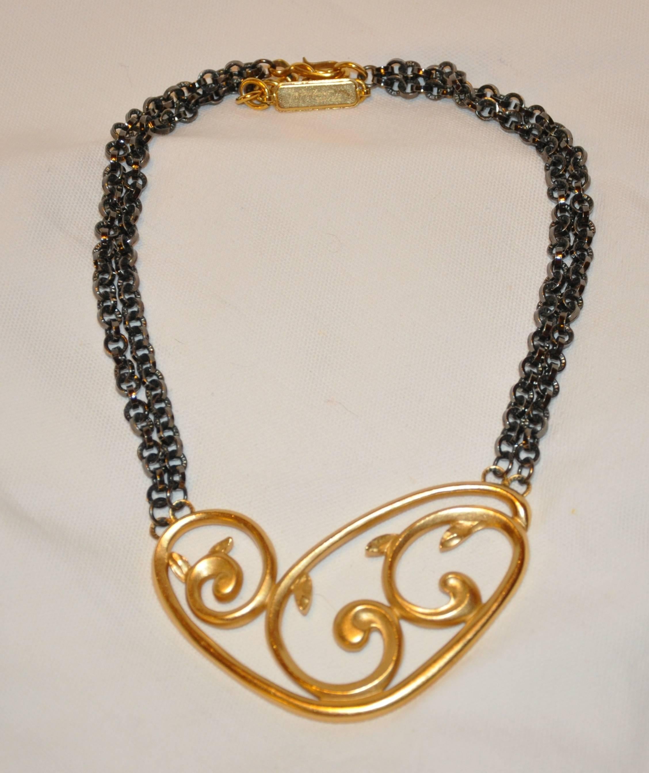        Yves Saint Laurent wonderfully elegant "Limited Edition" #331/500 two tier chain-link gunmetal accented with a huge pendant of polished gilded gold vermeil hardware of "Swirls". The adjustable chain-link necklace measures