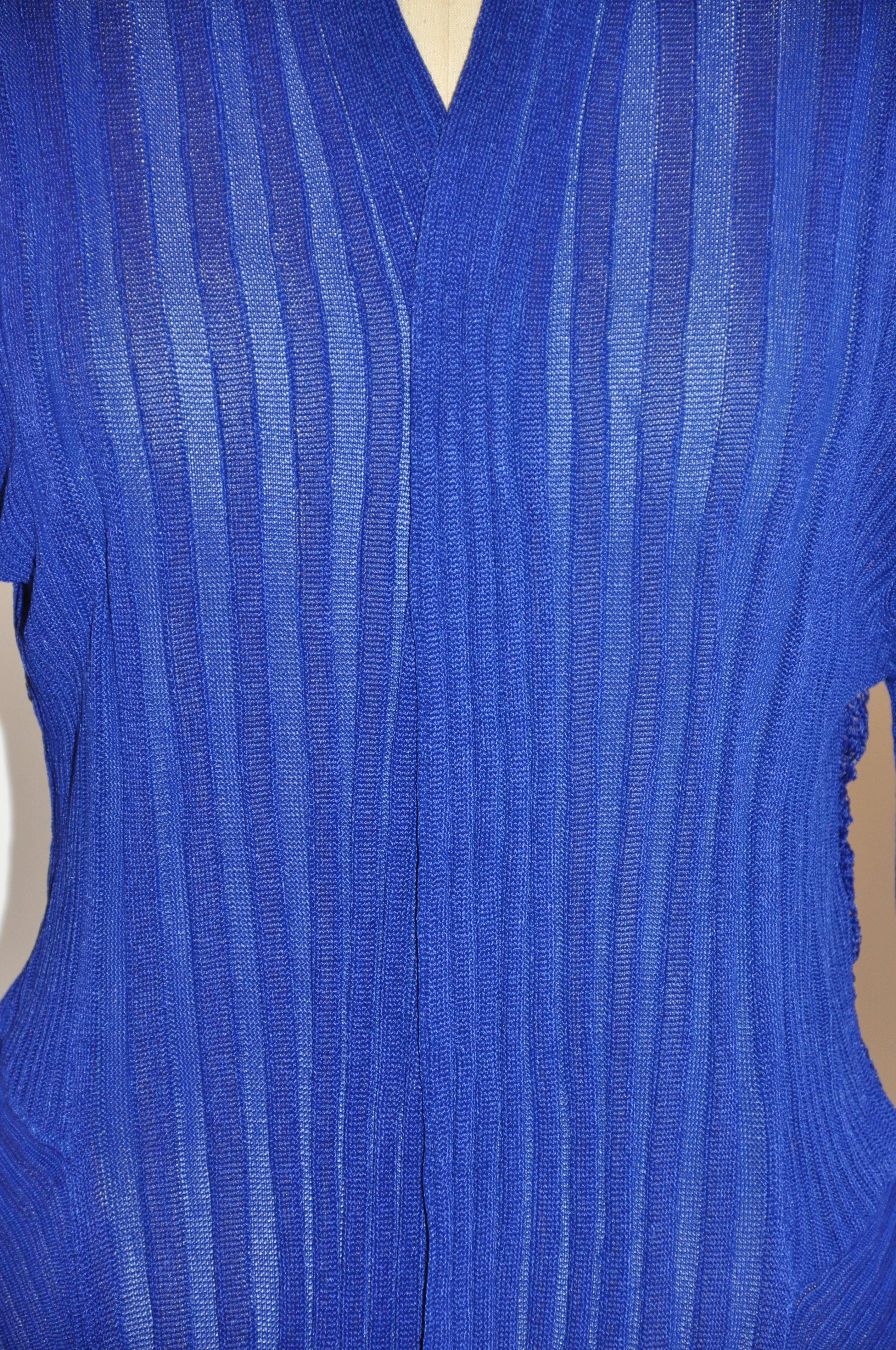        This wonderfully and beautifully draped bold blue lapis asymmetric accented with woven lace on the backside open cardigan measures 31 - 36 inches in length. The shoulder measures 18 inches across, sleeves are 27 inches, collar width is 6