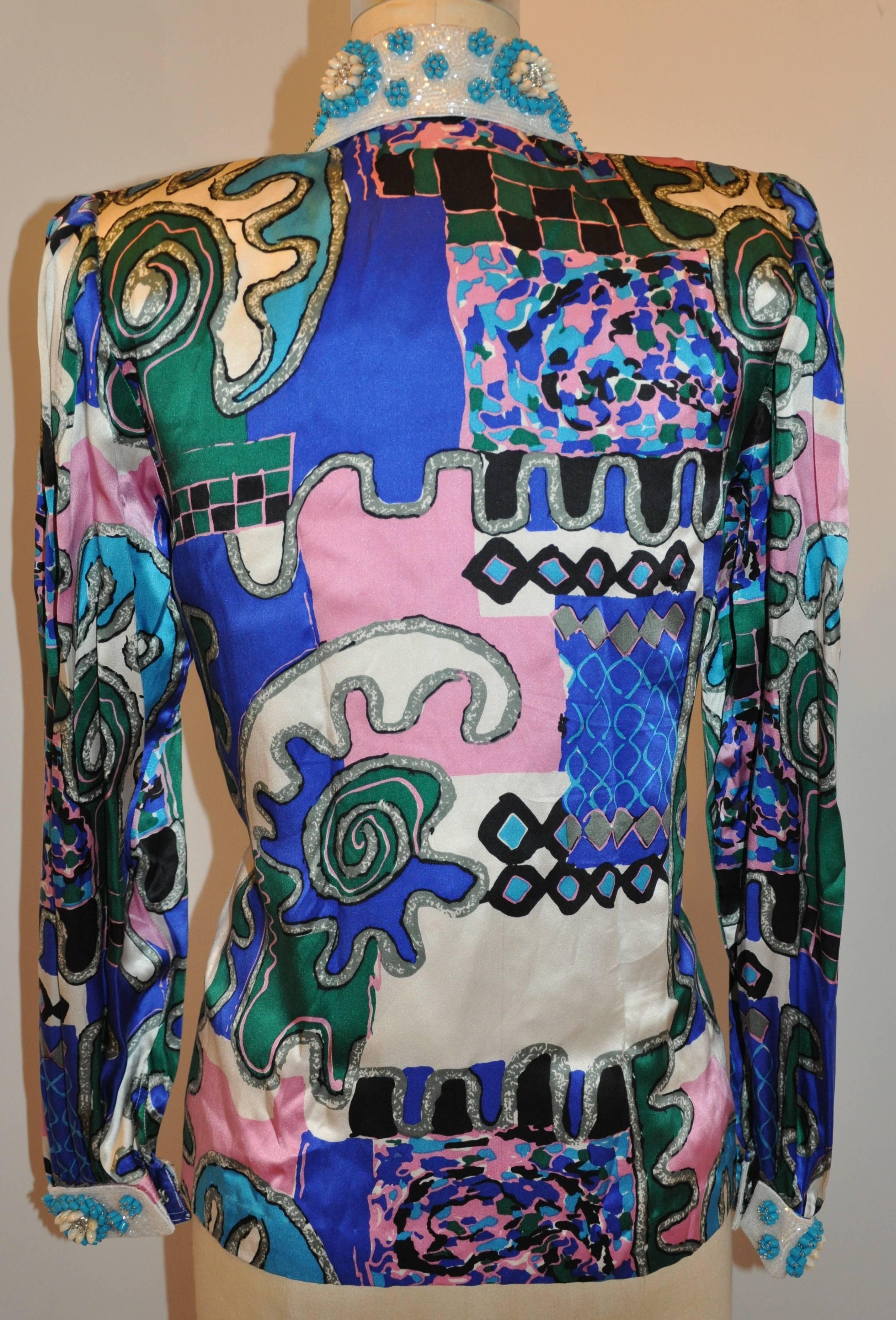      Yves Saint Laurent bold multi-color Abstract silk blouse embellished with micro beaded as well as turquoise shades and shells along the collar and cuffs as well as the front embellished buttons. The front has hidden hook & eyes for closing with