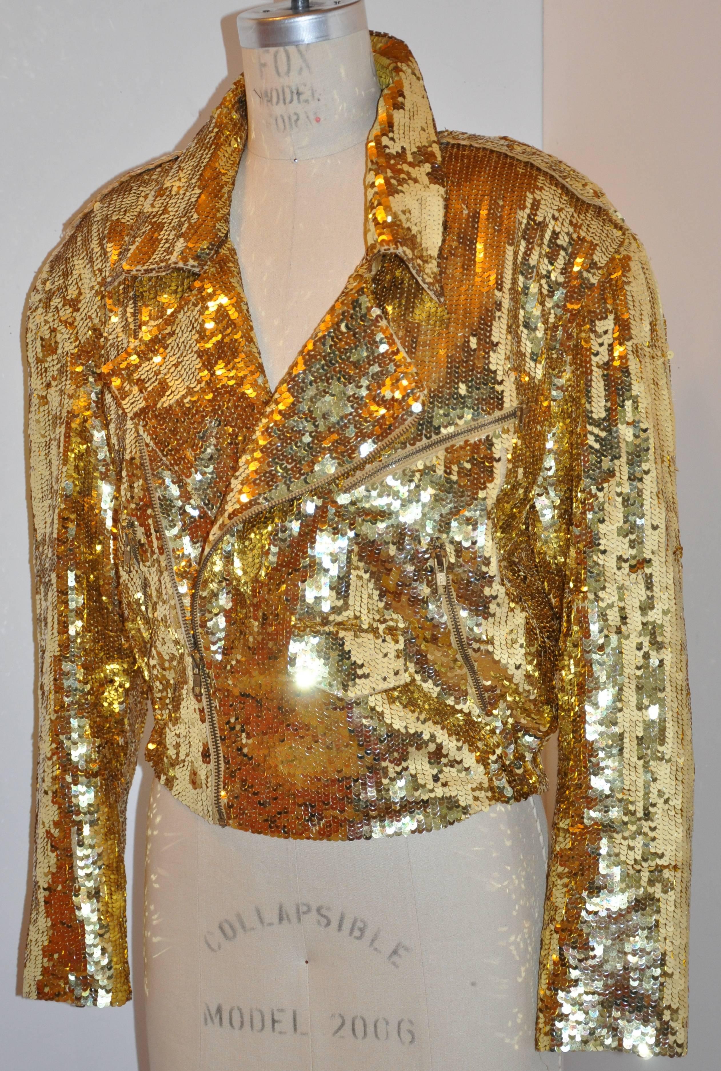      The famed Iconic Lillie Rubin of Park Avenue golden metallic sequin zipper motorcycle jacket features a front zipper as well as zippered front pockets and cuffs. The sequin collar is finished with micro bugle beads on the edge. The length