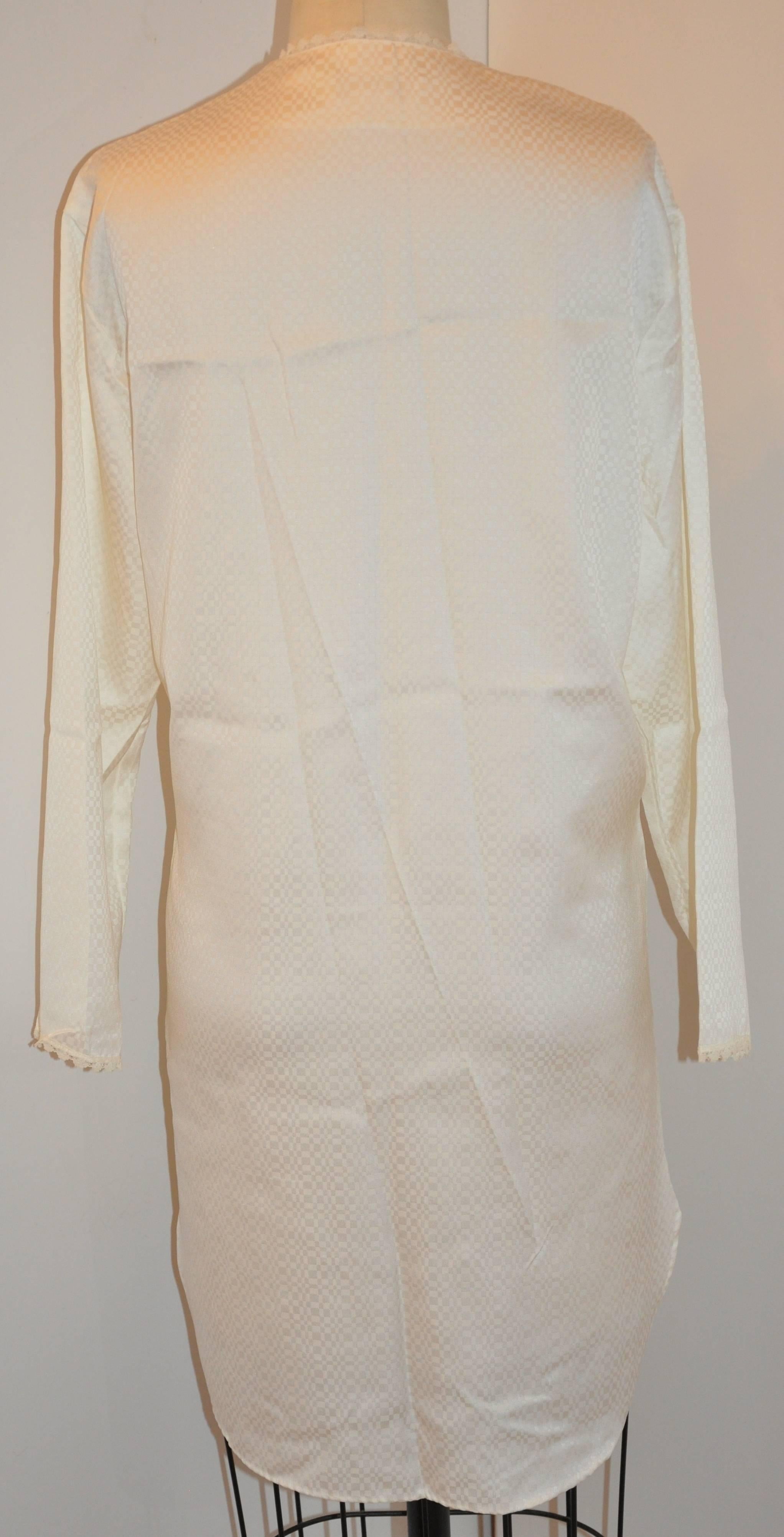      Christian Dior for Saks Fifth Avenue wonderful ivory & lace detailing button front night-shirt is accented with lace edges as well as the front patch pocket with lace over lace. The scallop hemline has side slits and finished with