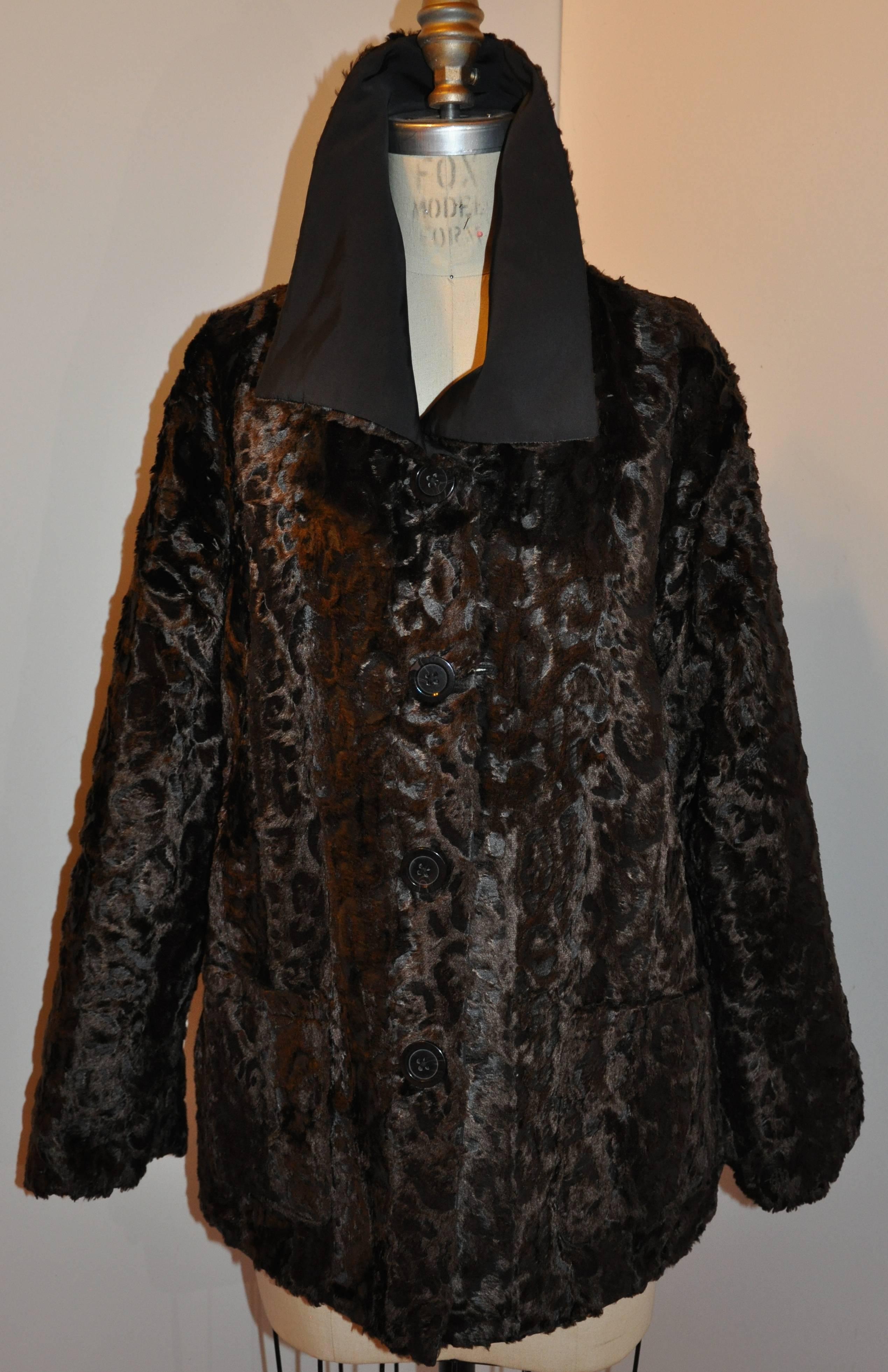        Wonderfully detailed in this reversible silk and faux-fur button evening jacket. The buttons, which features one side coco-brown, the other side, jet black, the black silk side is accented with two set-in pockets in front. The coco-brown