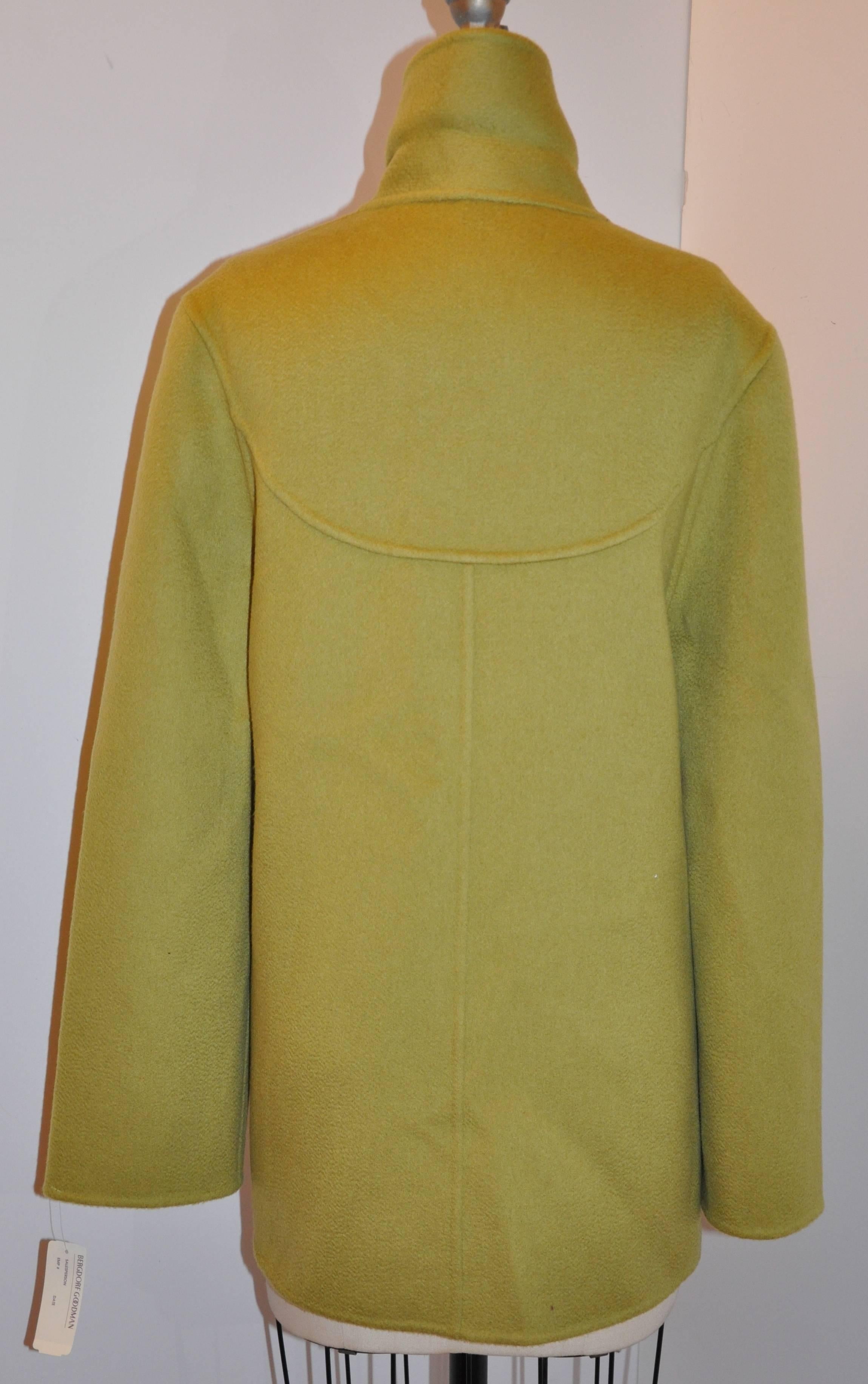        Bill Blass/Bergdorf Goodman warm olive green double-faced 2-ply cashmere open car coat features two set-in pockets in front. The interior of the two front pockets are finished with hand-stitched silk cord edges to keep the pockets flat in the
