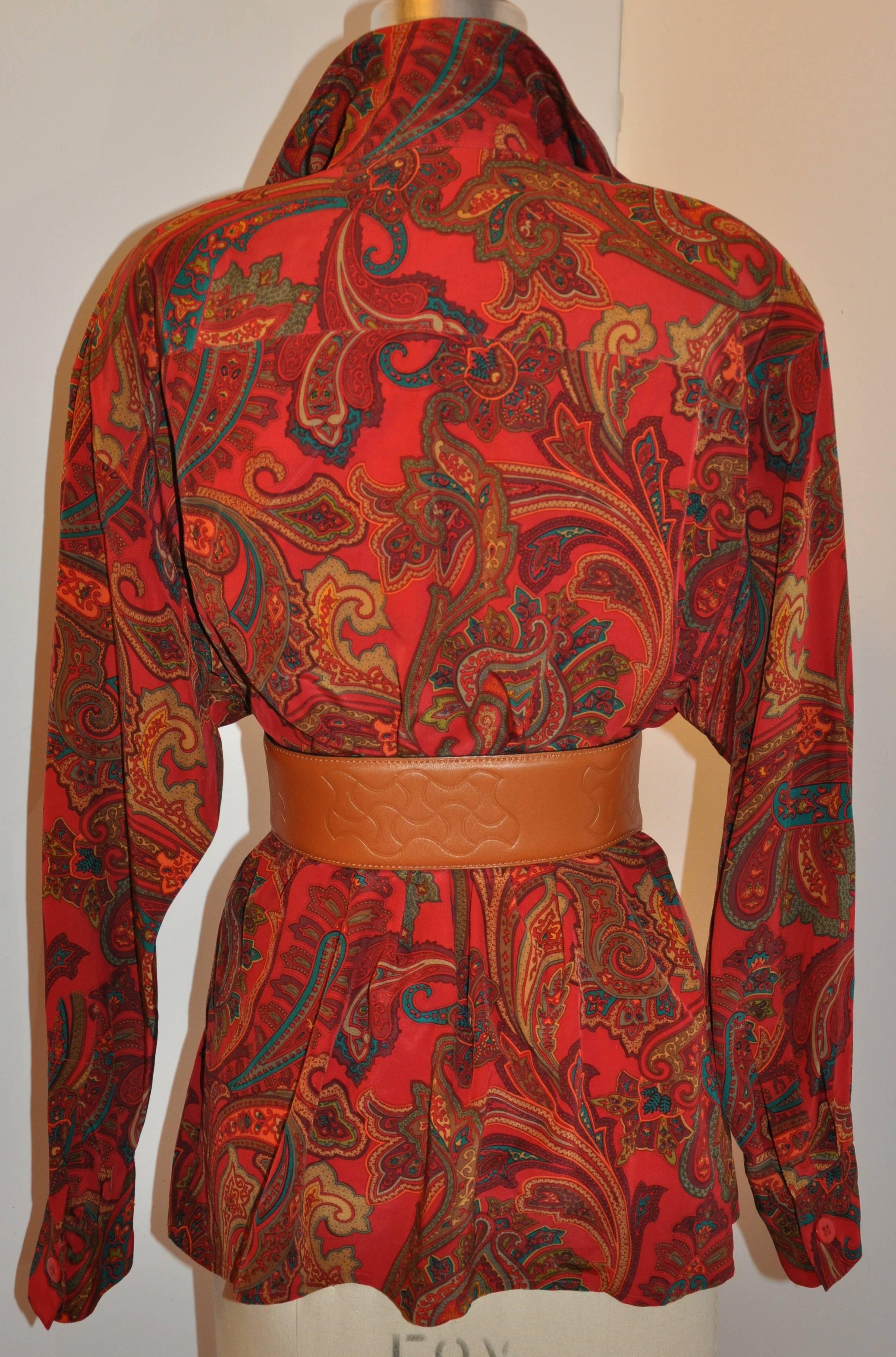        Ellen Tracy's wonderful elegant bold multi-color palsey high-collar silk blouse has slightly dropped shoulders with removable shoulder pads. The softly draped domain sleeves tapers to a fitted cuff which measures 8 inches and a width of 2 1/2