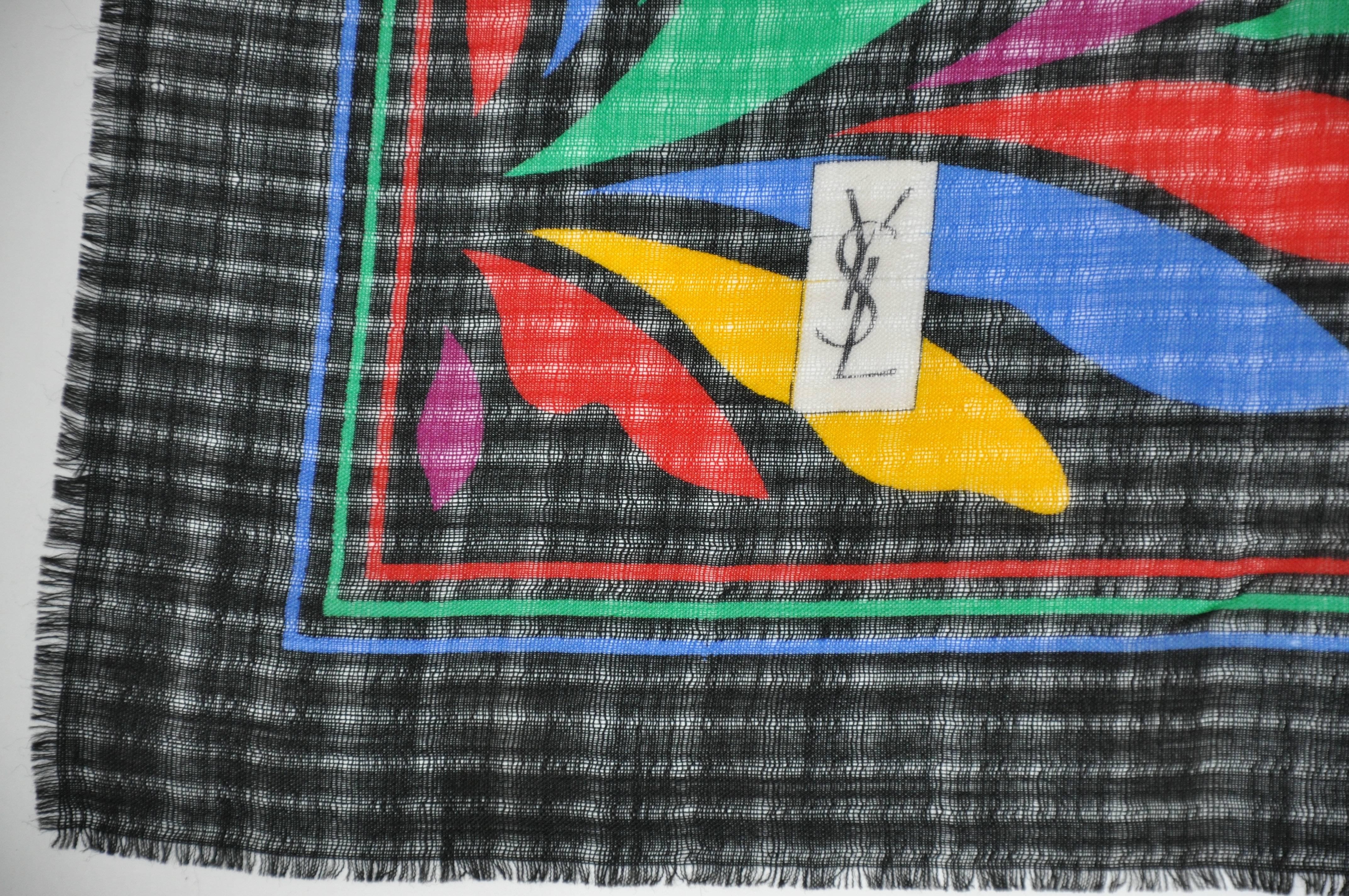        Yves Saint Laurent large Iconic black with multi color block floral wool challis fringed scarf measures 37 1/2 inches by 38 inches. Made in Japan.