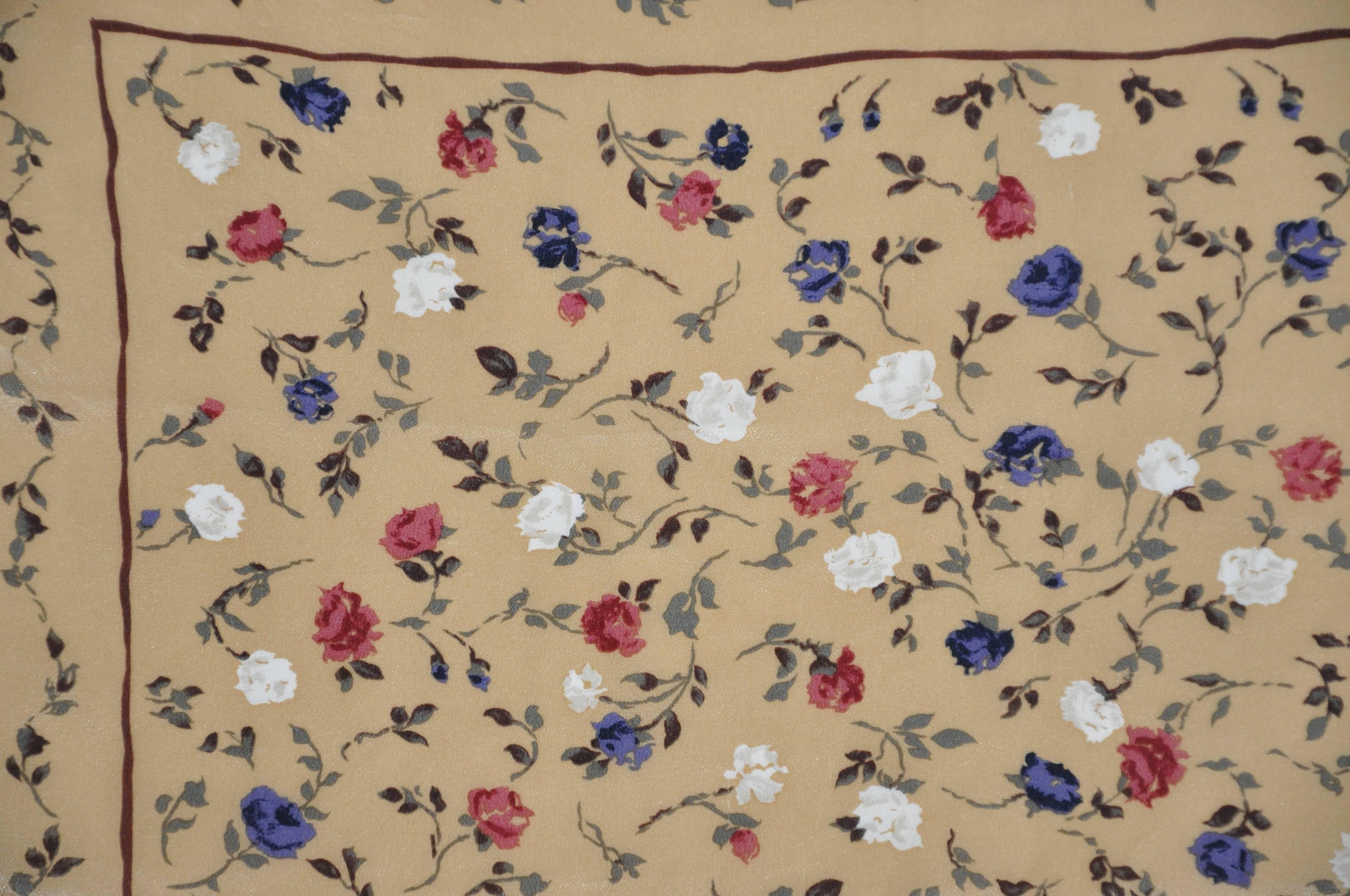      This wonderfully warm beige accented with multi-colors of floral silk handkerchief measures 18 1/2 inches by 19 inches. Made in Italy.