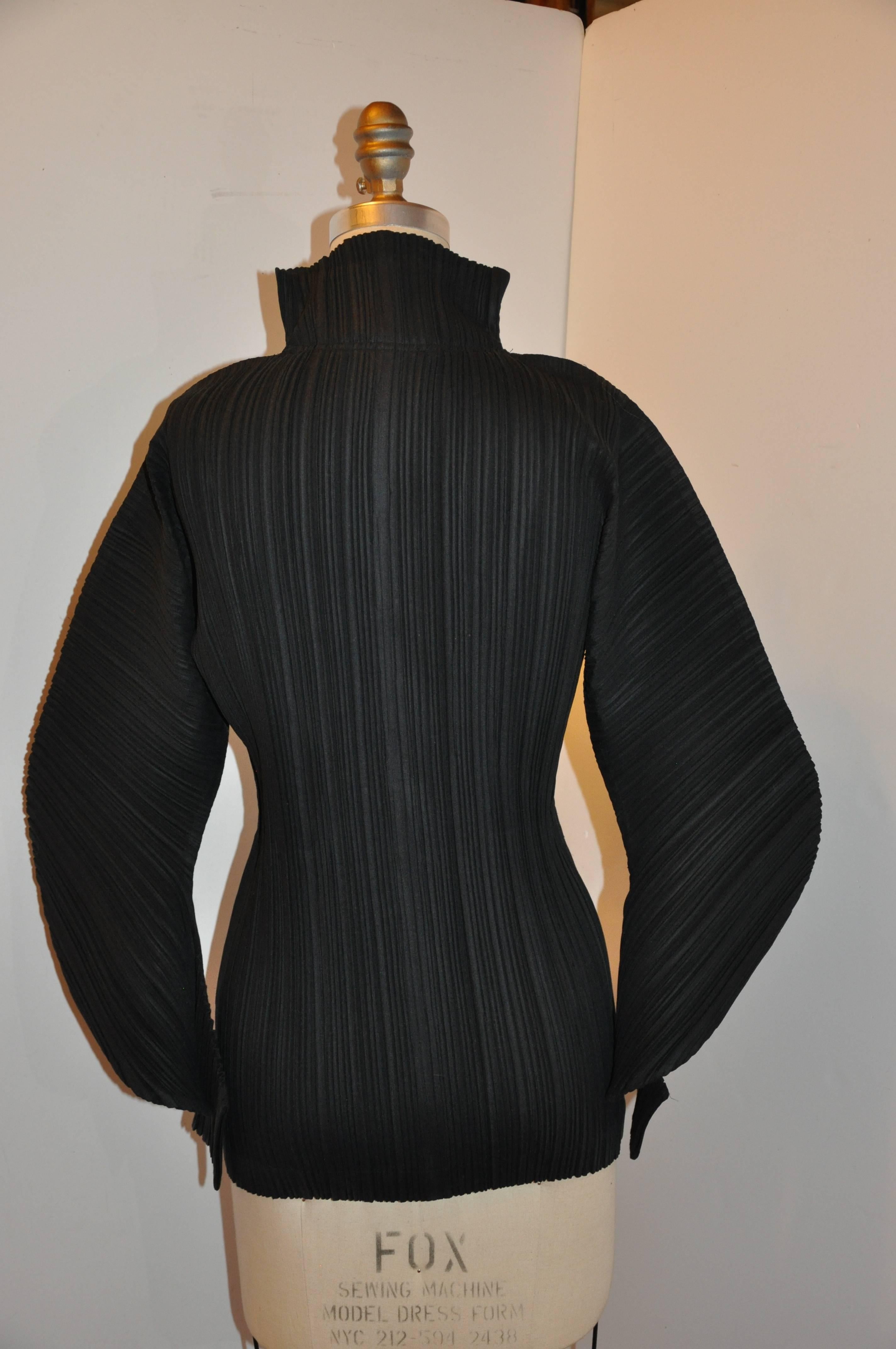        Issey Miyake wonderful signature black double zipper high neck zipper-front optional top or jacket accented with deconstructed sleeves measures 28 inches in length on the front, and 29 inches in back. Underarm circumference measures 32 to 44