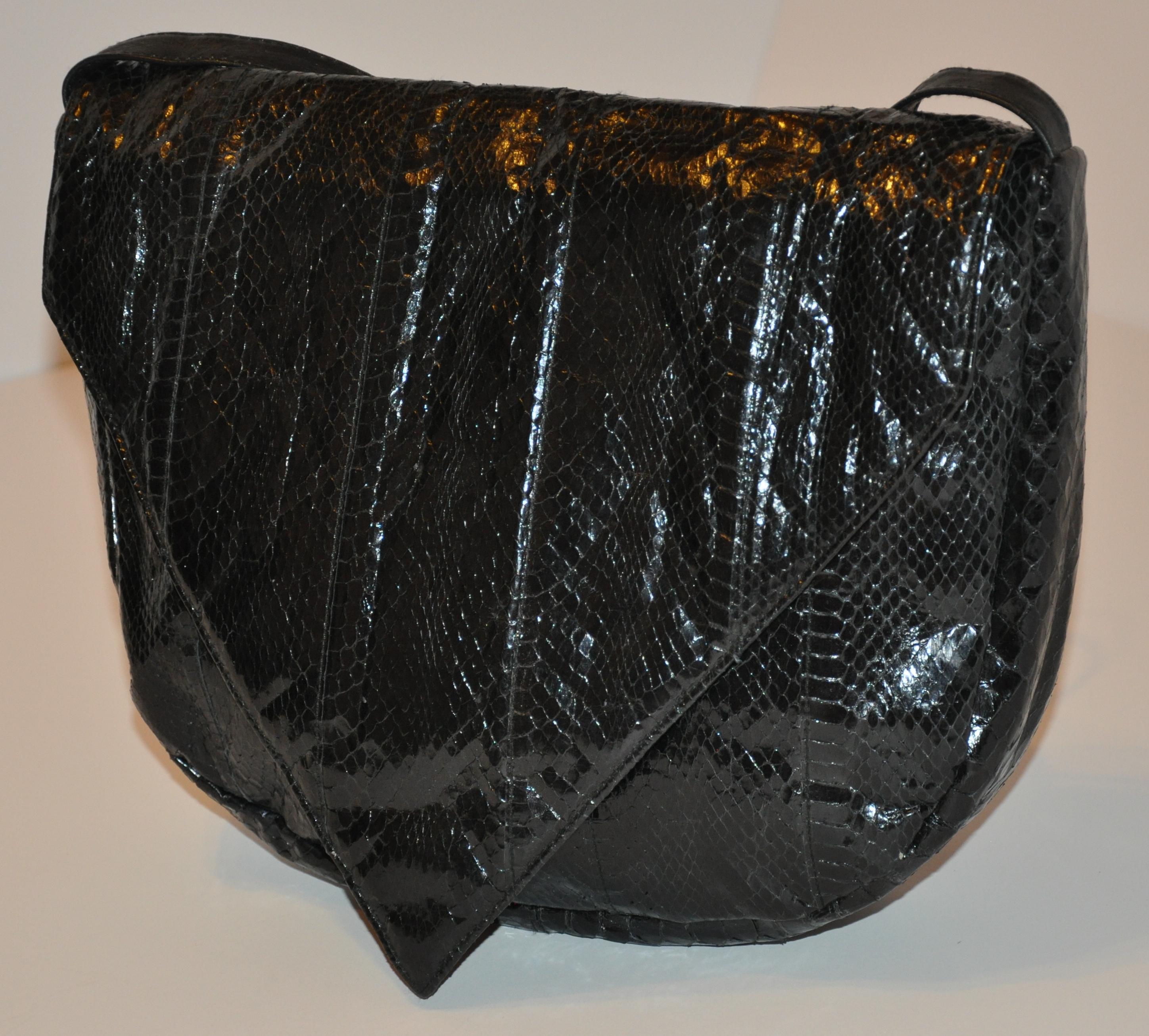        This wonderfully soft huge black snakeskin accented with black calfskin has the option to be used either as a clutch as well as a shoulder bag if desired. The 