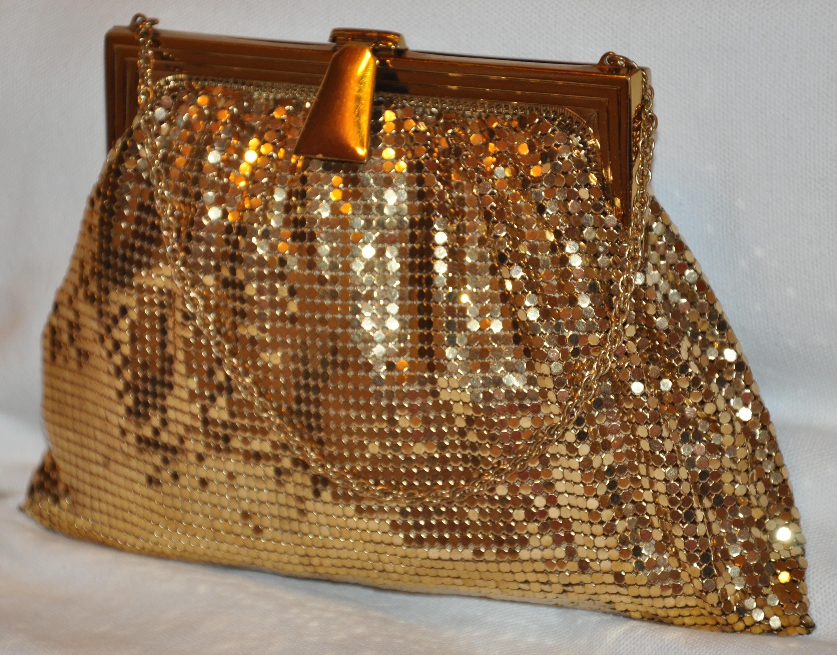        Whiting & Davis wonderfully elegant gilded gold hardware mesh evening bag is accented with a matching gilded gold hardware chain strap which measures 5 inches in height. The length measures 8 inches along the bottom and 5 inches along the