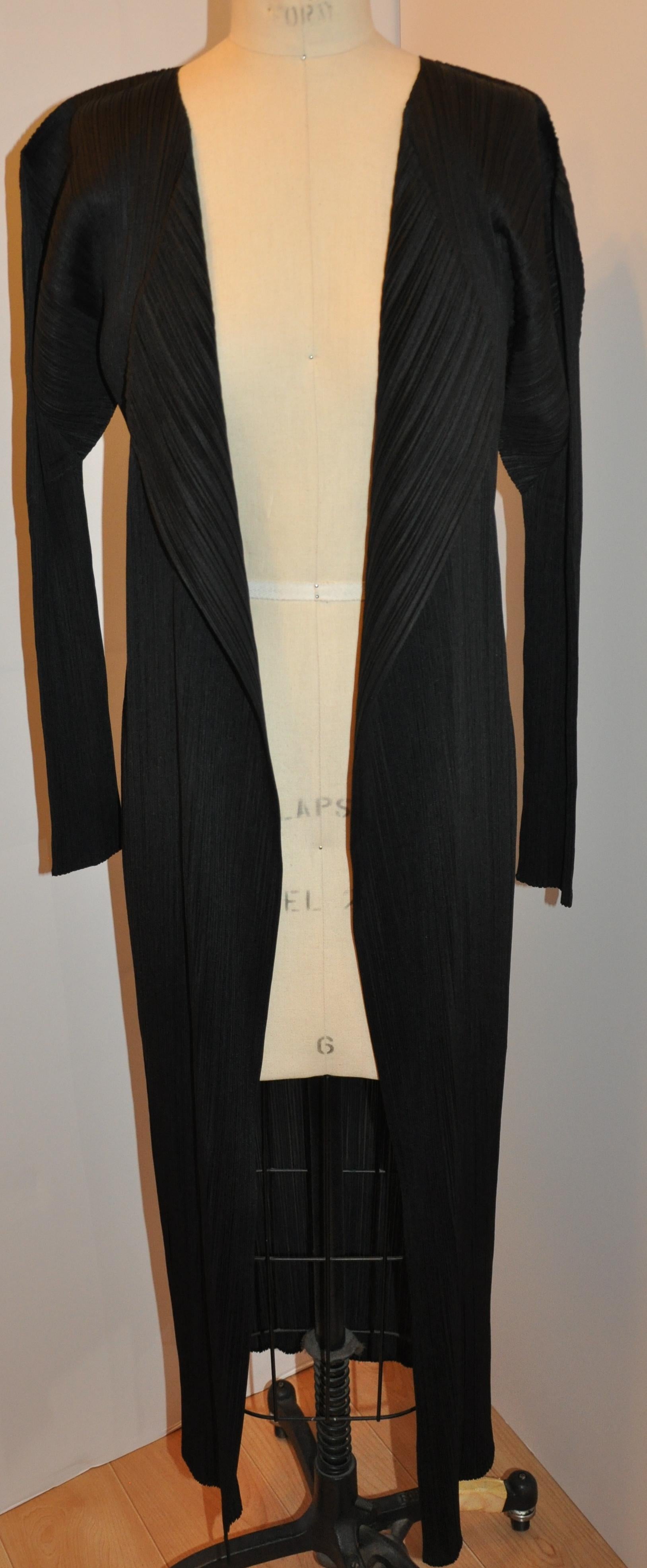        Issey Miyake signature black accordian open coat measures 50 inches in total length. Shoulders are 22 inches across, sleeve is 22 inches in length, neck-to-shoulders are 6 inches. Size is 4/taille, made in Japan.