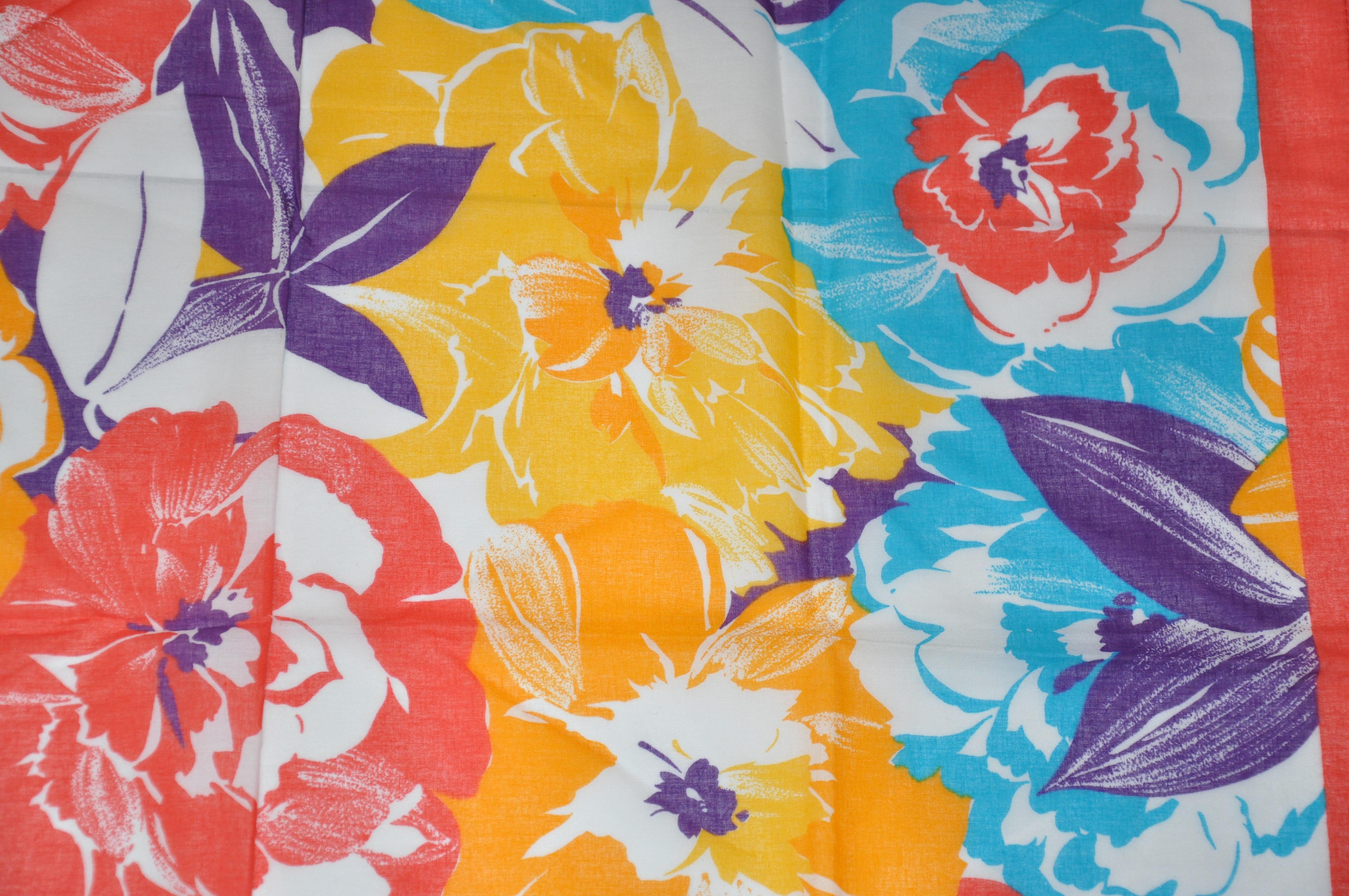        Le foulard en coton Multi Florals, aux couleurs vives et audacieuses, mesure 30 pouces sur 30, avec des bords micro-cousus. Fabriquées en Italie.