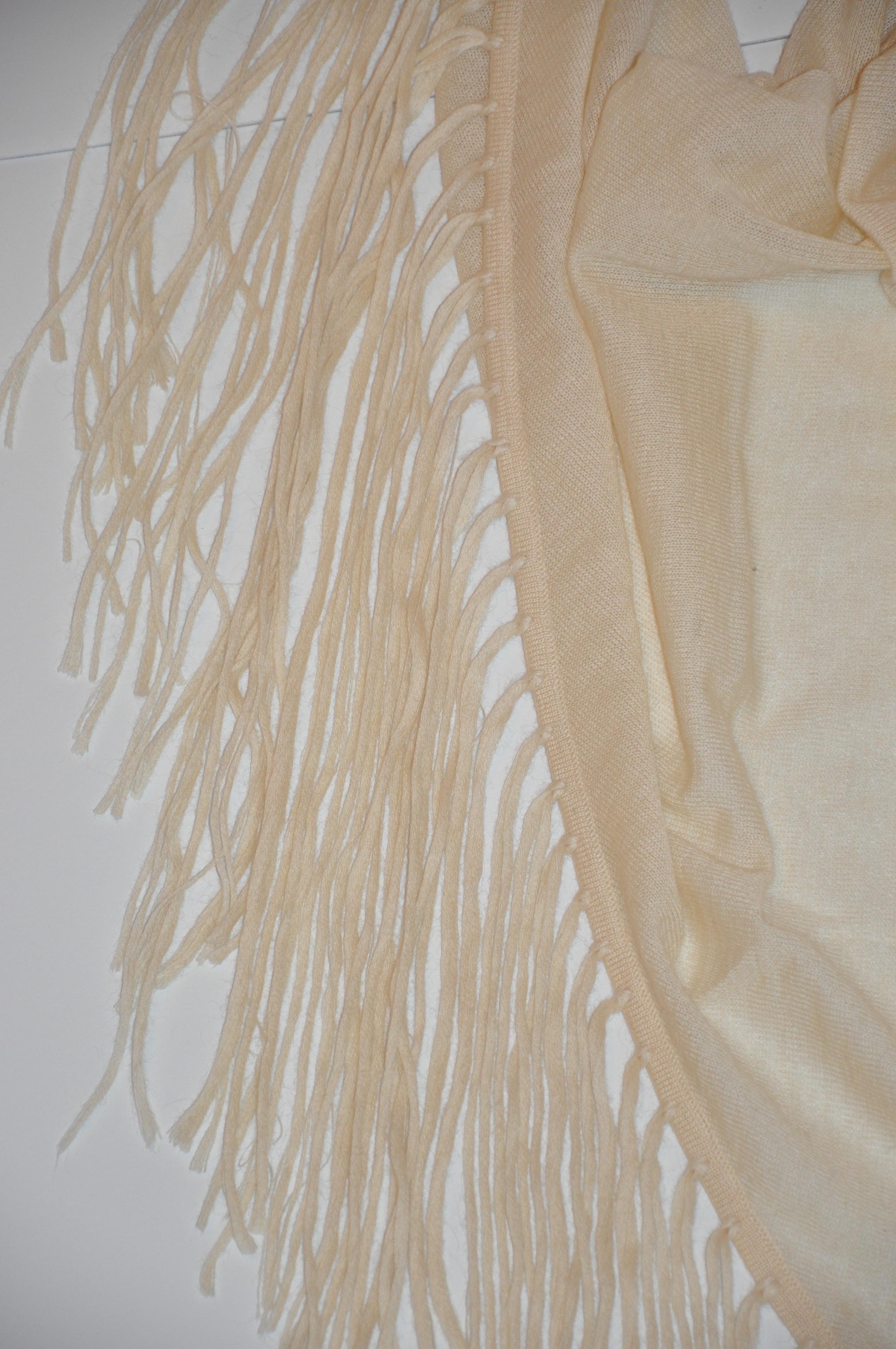        Bottega Veneta wonderful whimsical deconstructed woven cream fringed scarf and optional shawl made of 70% cashmere with 30% mohair blend has multi-size fringes measuring from 5 inches to 16 inches in length. The scarf measures 94 inches by 32