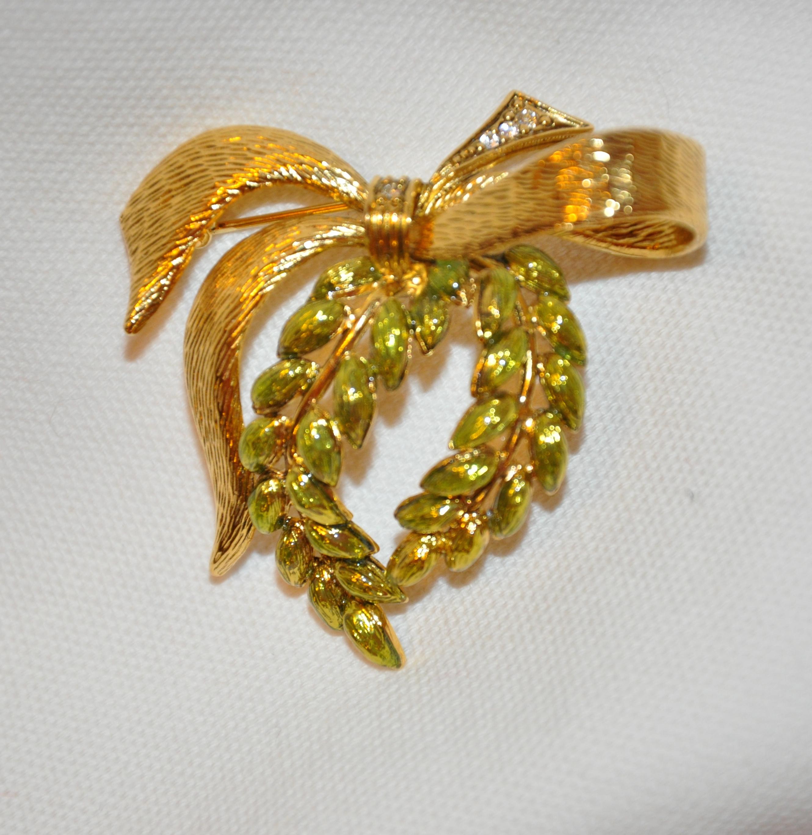        Wonderfully Detailed gilded gold hardware accented with fresh-green enamel 