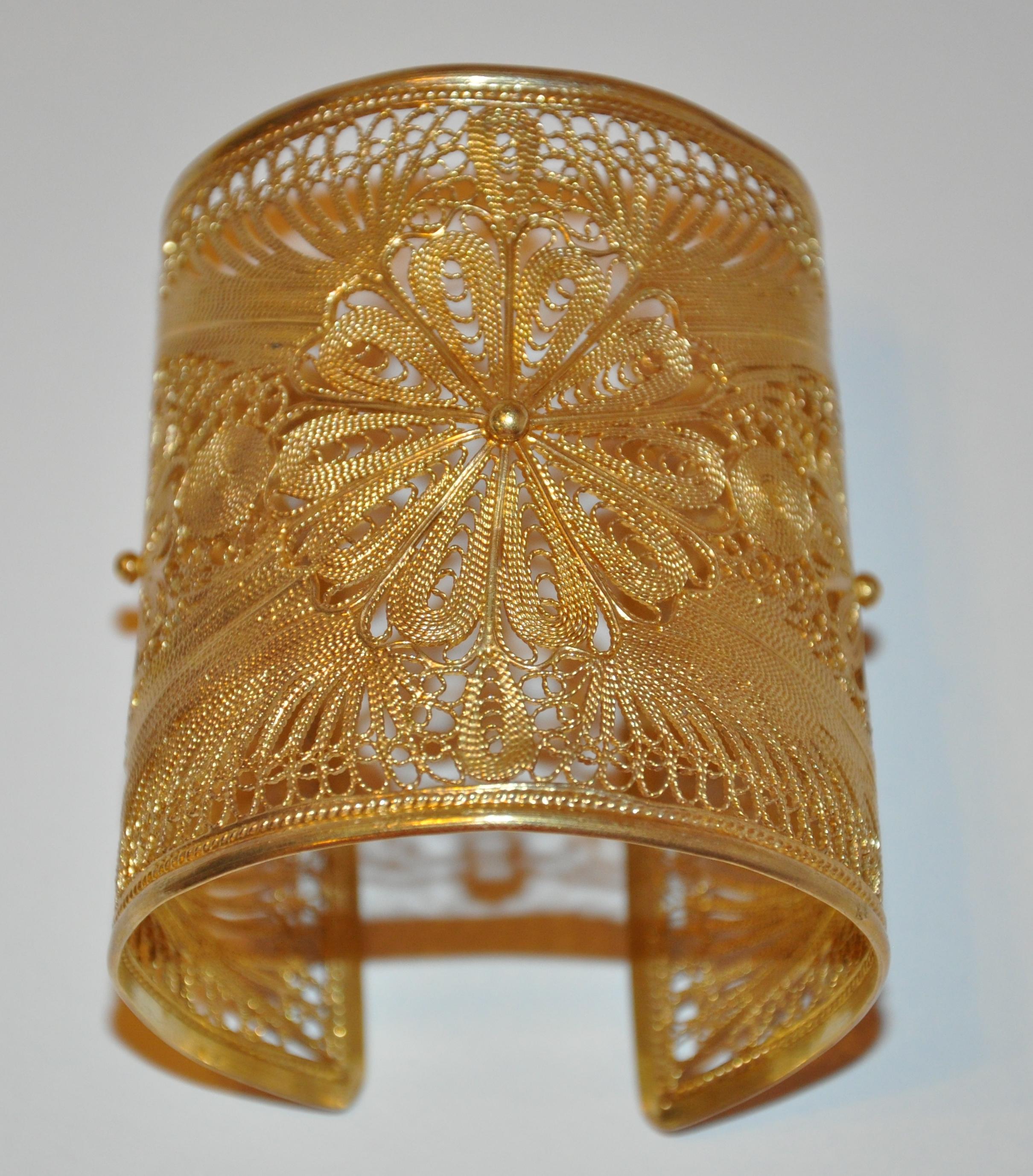      Yvone Christa wonderfully detailed filigree silver based with gold-plated overlay cuff measures 2 3/4 inches in width. The circumference measures 7 inches and 7 5/8 inches respectively. Made in US. 