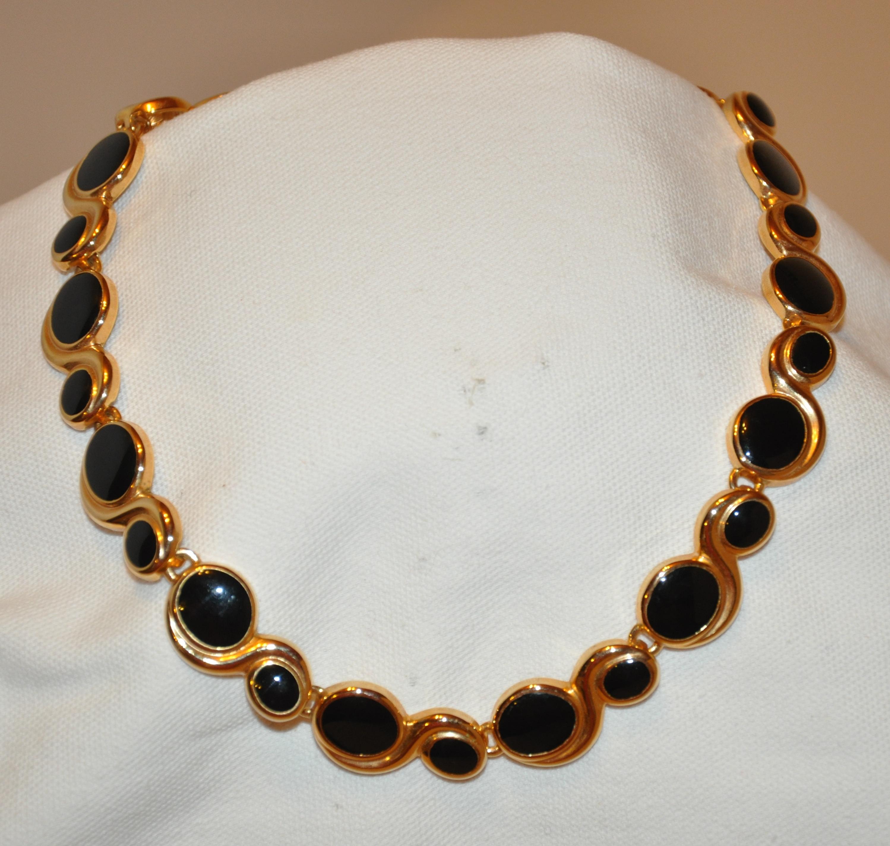        Wonderfully elegant, this sculpted gilded gold vermeil hardware choker necklace is accented with onyx-like stones. The necklace measures 18 inches in total length. Width measures 5/8 inch. Made in US.