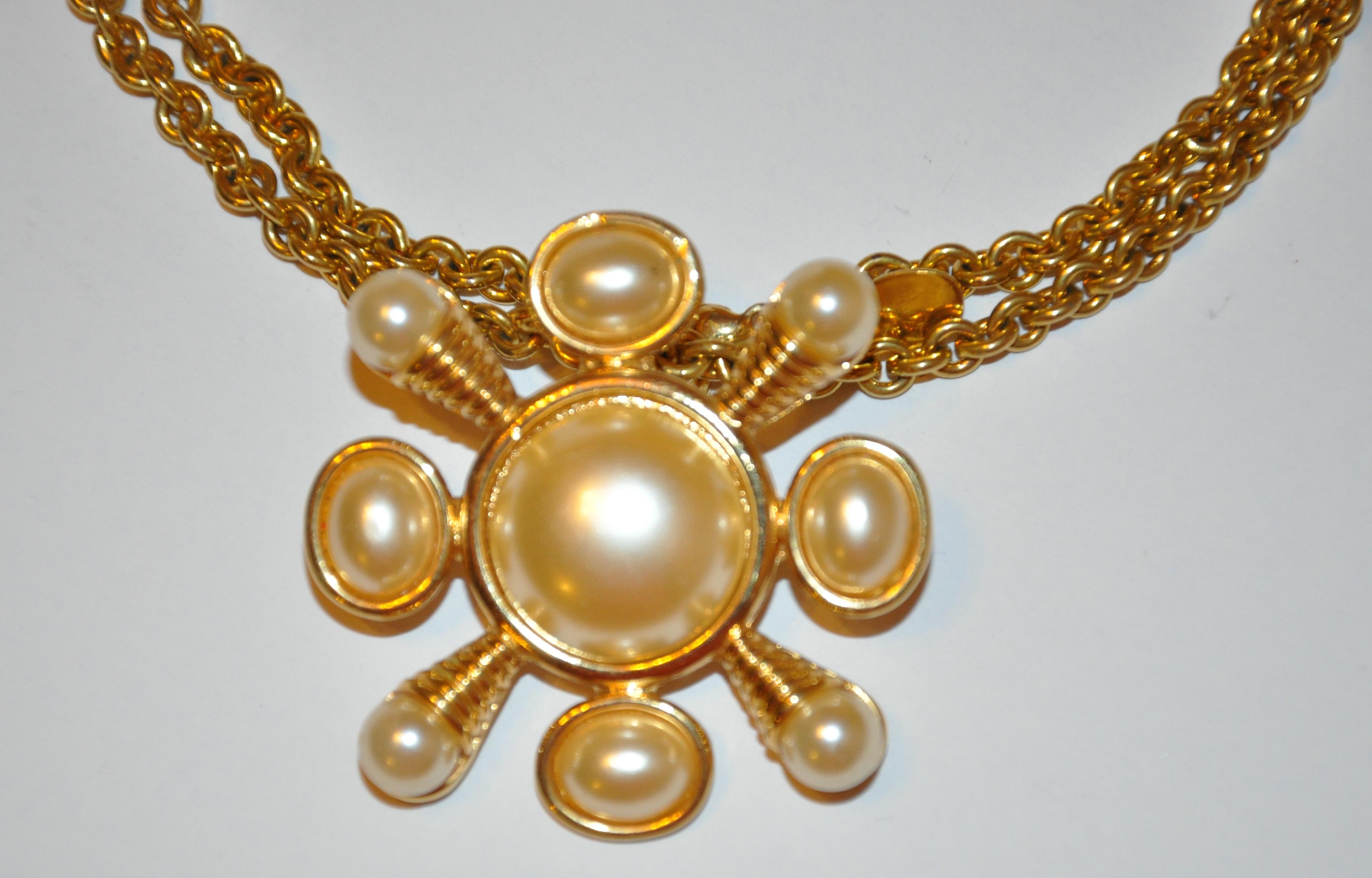        Kenneth Jay Lane etched gilded gold vermeil hardware accented with multi-size pearl-like embellishments, has the optional choice of being worn as a pendant or, as a brooch for your desire. The brooch itself measures 1 6/8 inches by 1 6/8