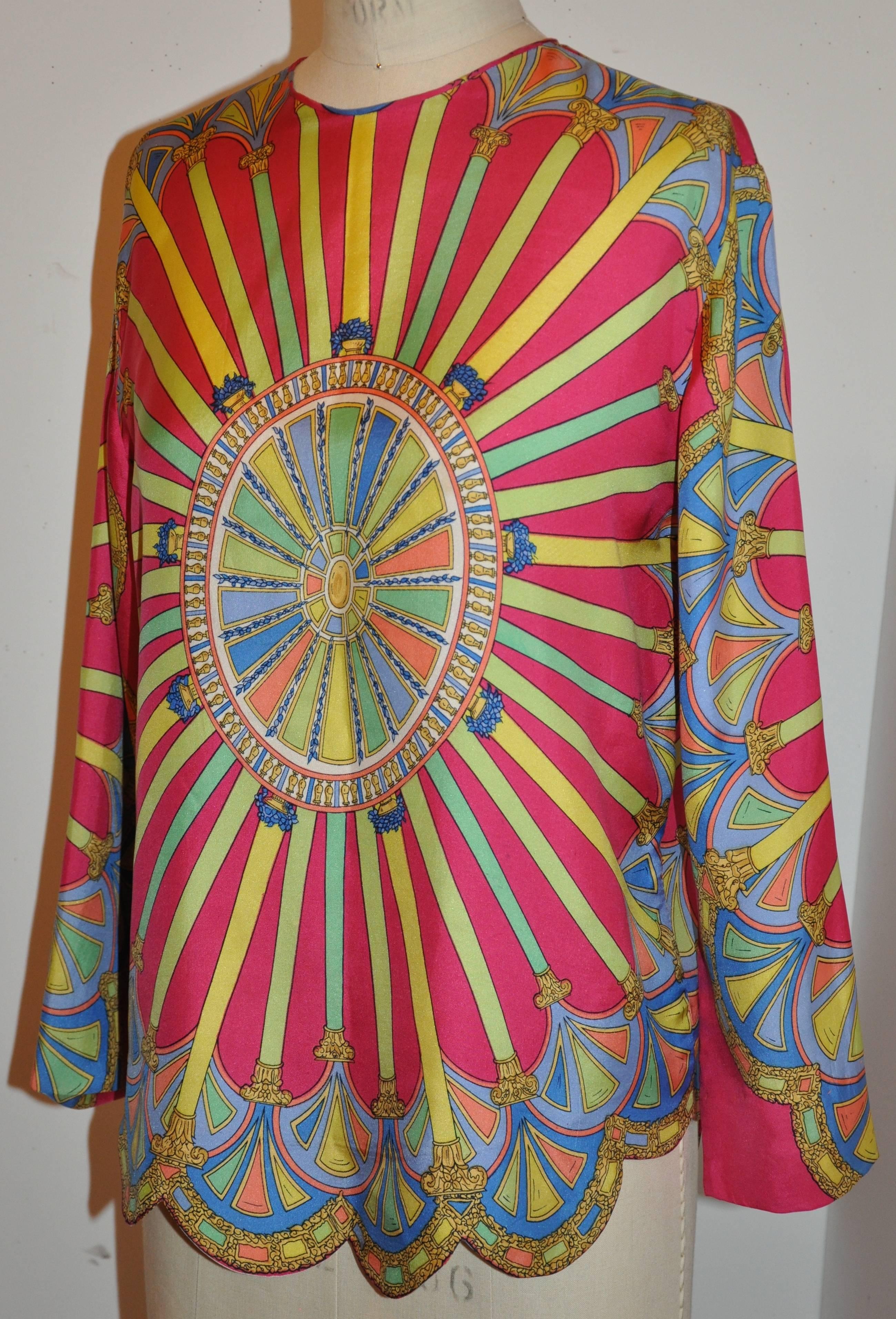      This wonderful whimsical multi-color multi-print silk top has detailed scallop hemline as well as silk piping along the edges of the same silk material. This wonderful top can be worn either with a taper pair of trousers or a slim pencil