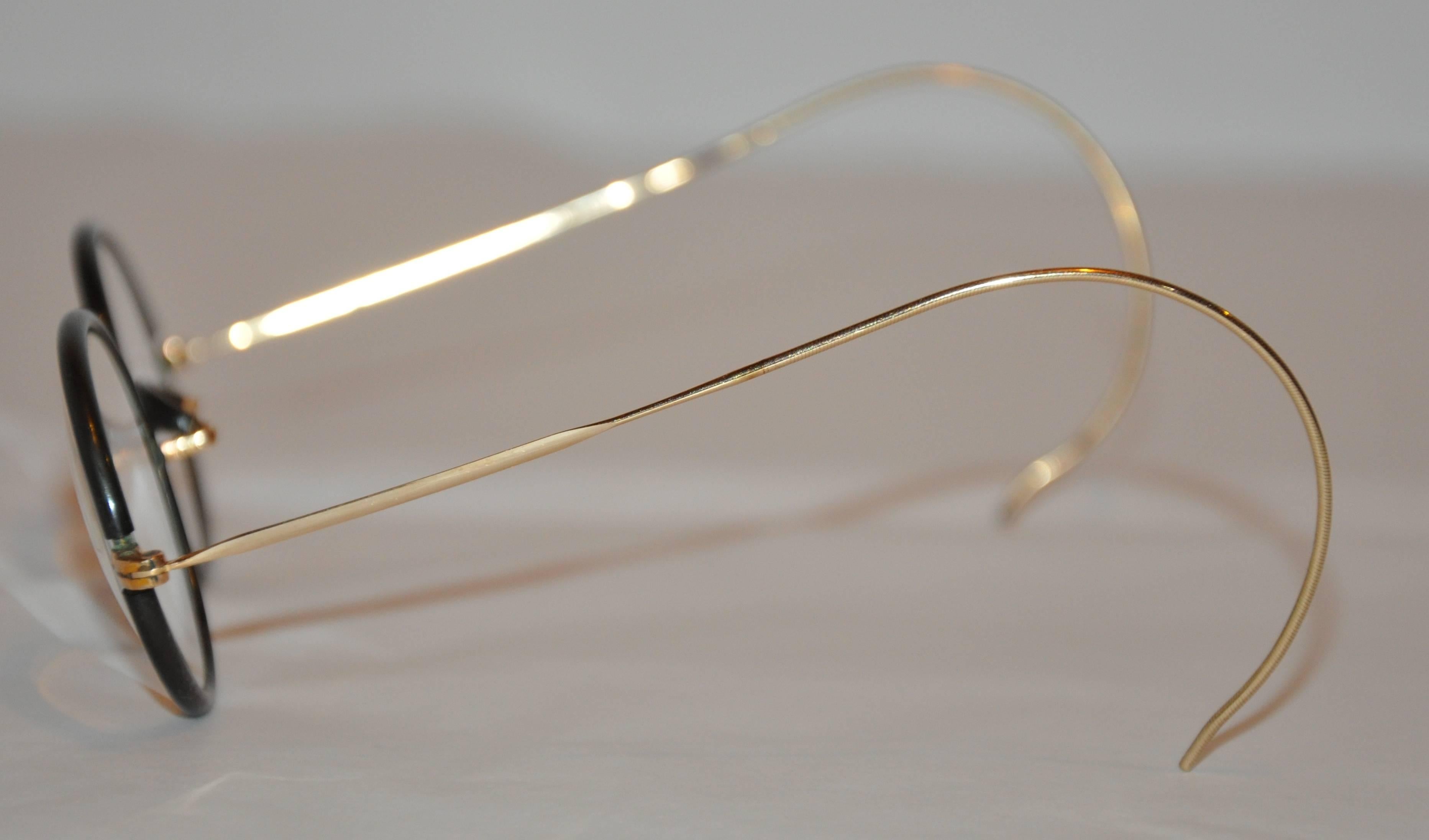              These wonderfully custom made-to-order black lucite is combined with 1/20 12k yellow gold as well as genuine horn accenting the center front of these eyeglasses. The 1/20 12k yellow gold arms can be adjusted, if desired.
            The