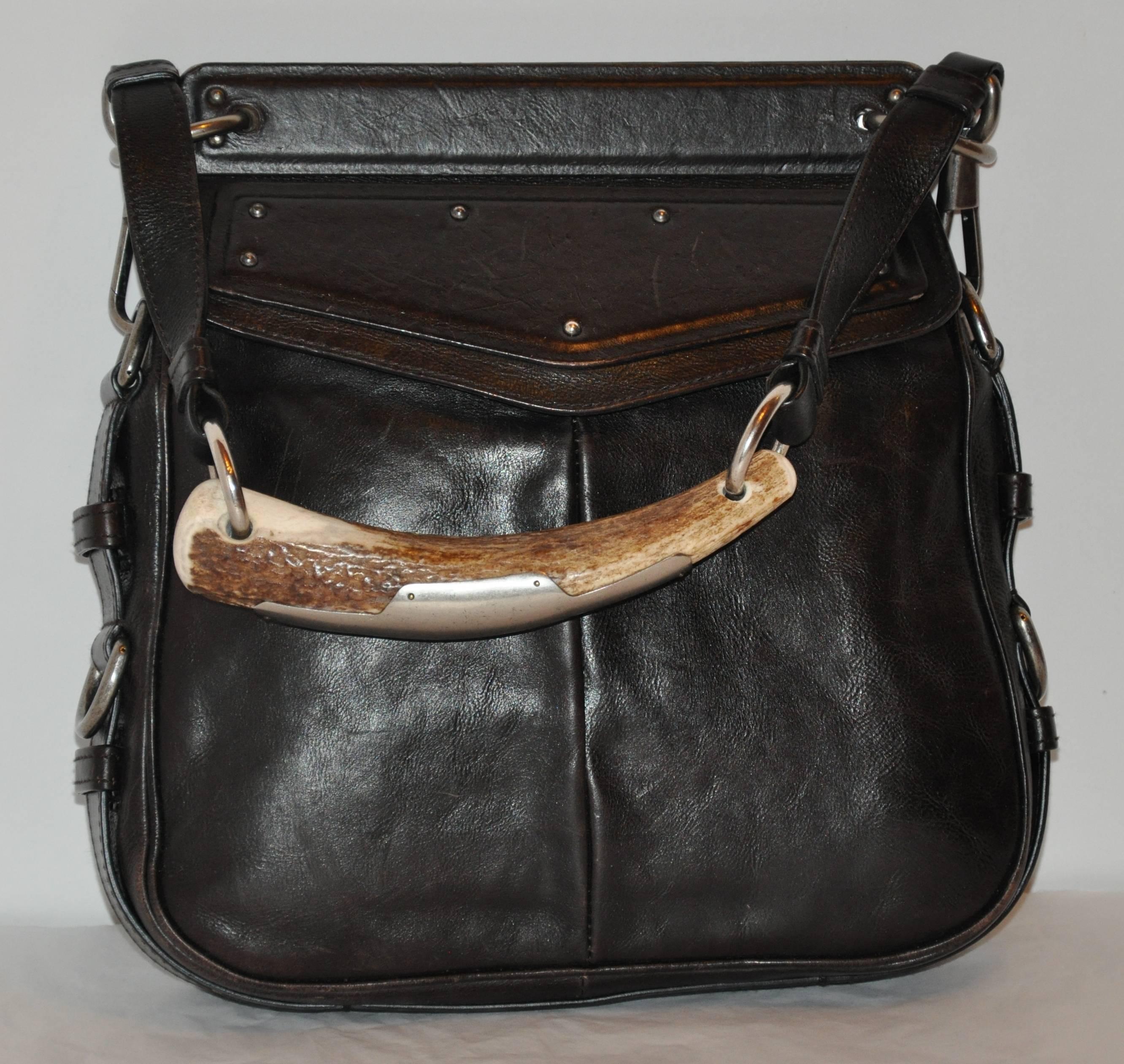              Yves Saint Laurent detailed black calfskin handbag features a large 