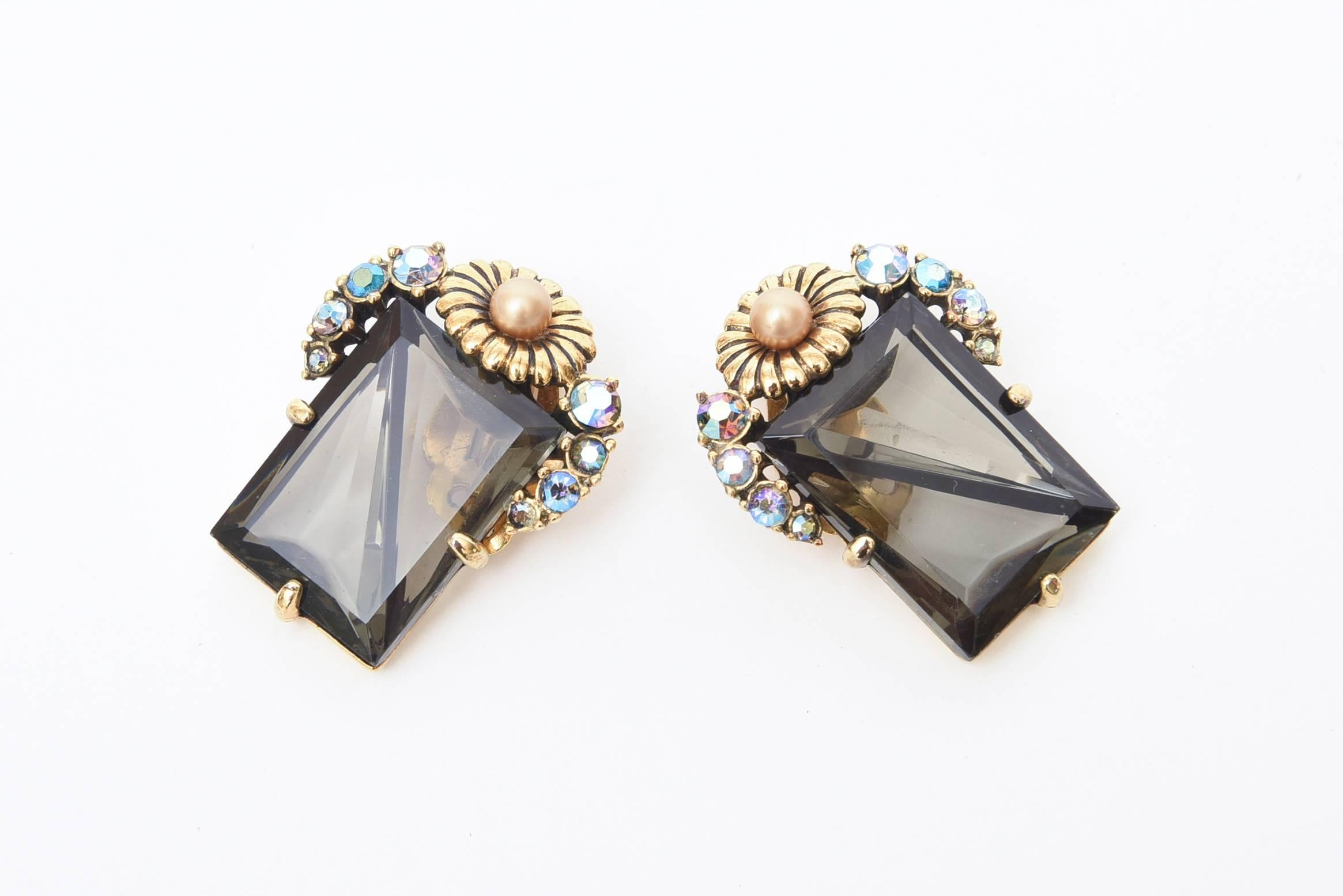The combination of faceted smoky topaz crystal glass with turquoise Boris Aurealis glass stones and clear rhinestones set of with a flower top in gilt metal make these signed vintage Elsa Schiaparelli clip on earrings so elegant. They hug the ear