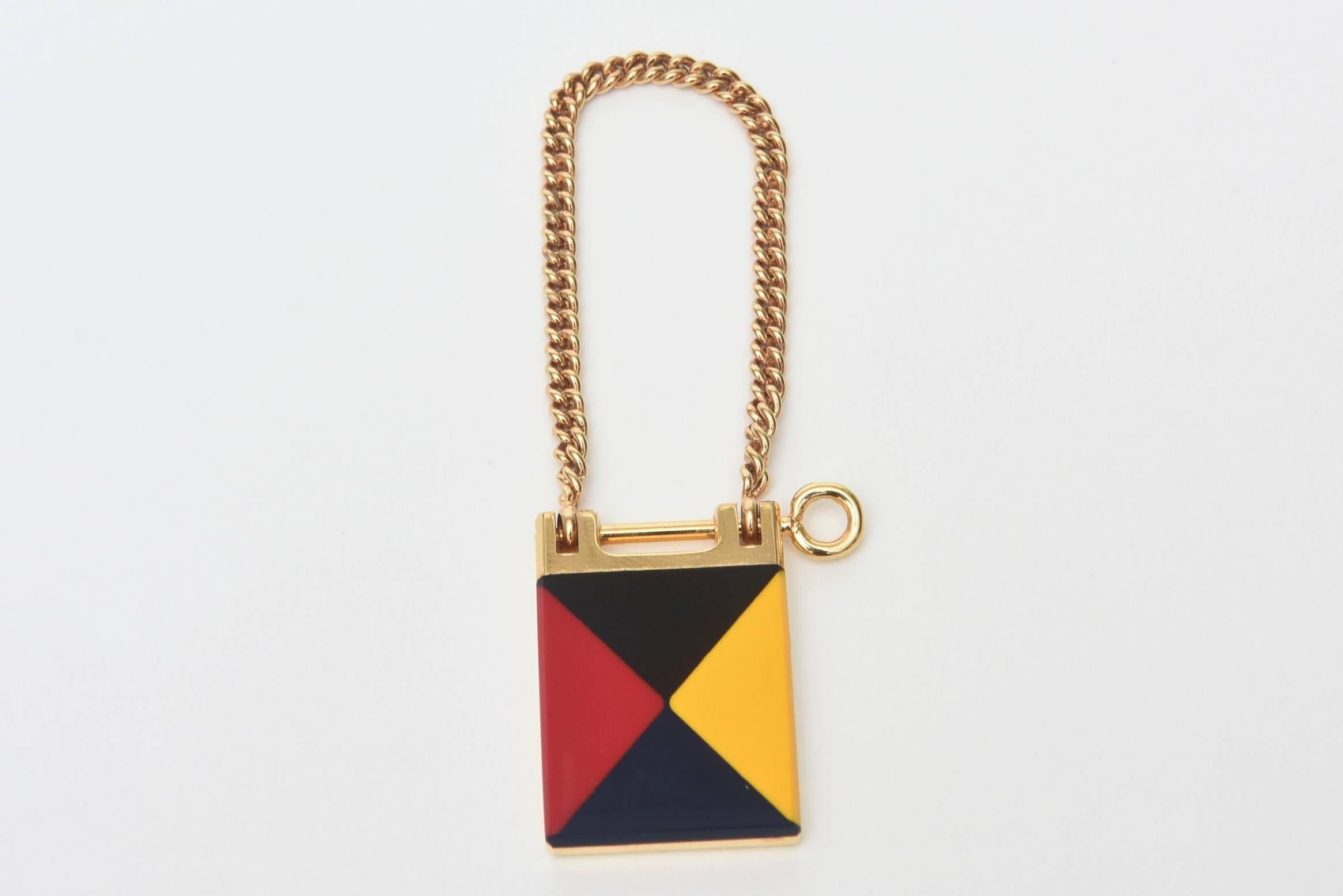  This signed Italian vintage Gucci enamel and gold plated key ring comes in it's own original box. It is very Mondrian style. What a chic way to carry your keys. This makes a great gift as well as a great keychains for your own pleasure.  It is from