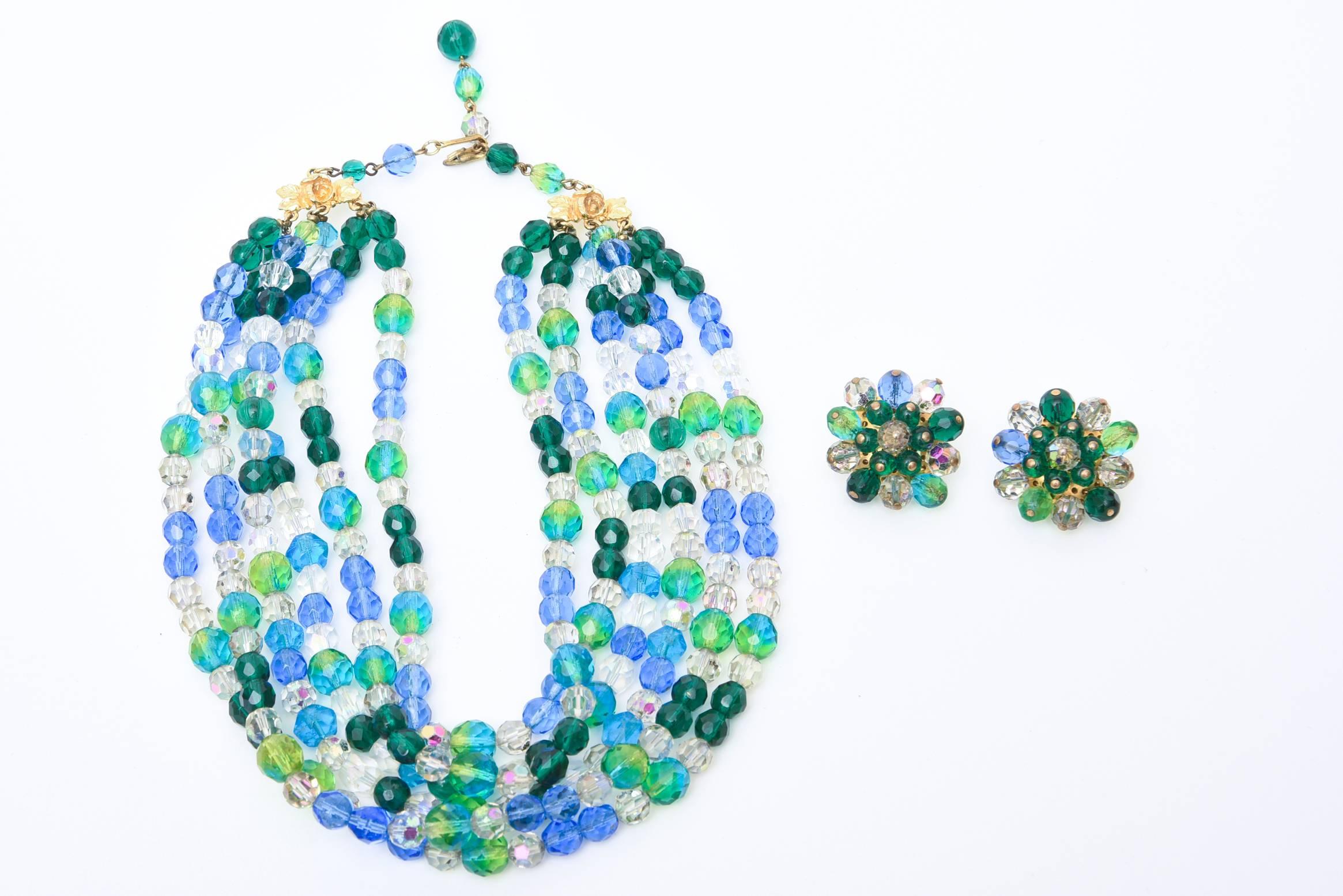 The colors of the sea in alternating glass beads of blues and greens make up this signed vintage stunning Elsa Schiaparelli necklace so wearable. There are 6 wide strands on each side of luscious colored glass beads and matching clip on cluster