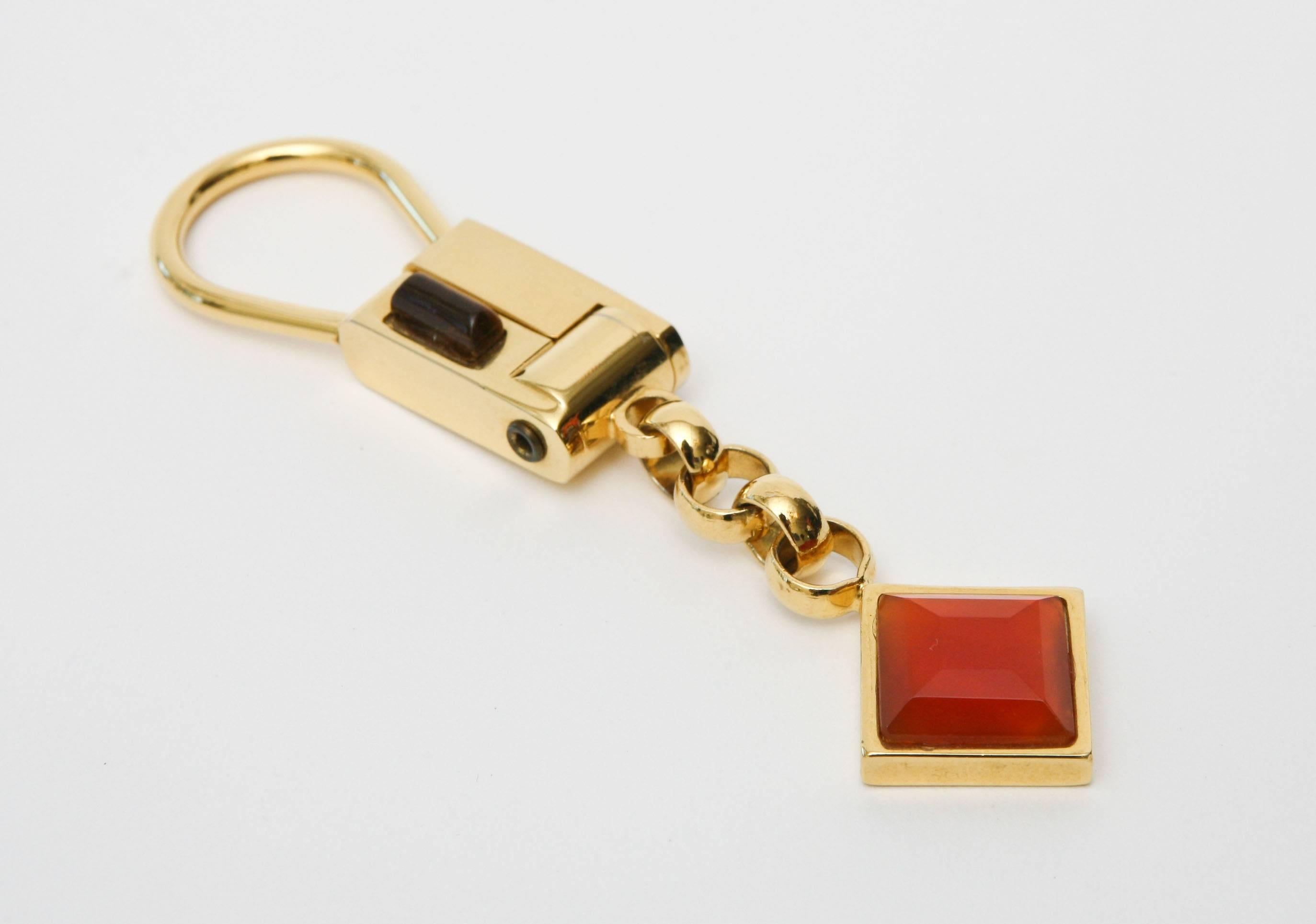 This beautiful Judith Lieber key chain is elegant. The mix of tigers eye and carnelian agate offset the gold plated areas of the key chain.
Stamped Judith Leiber New York. This is a classy way to dangle your keys.
