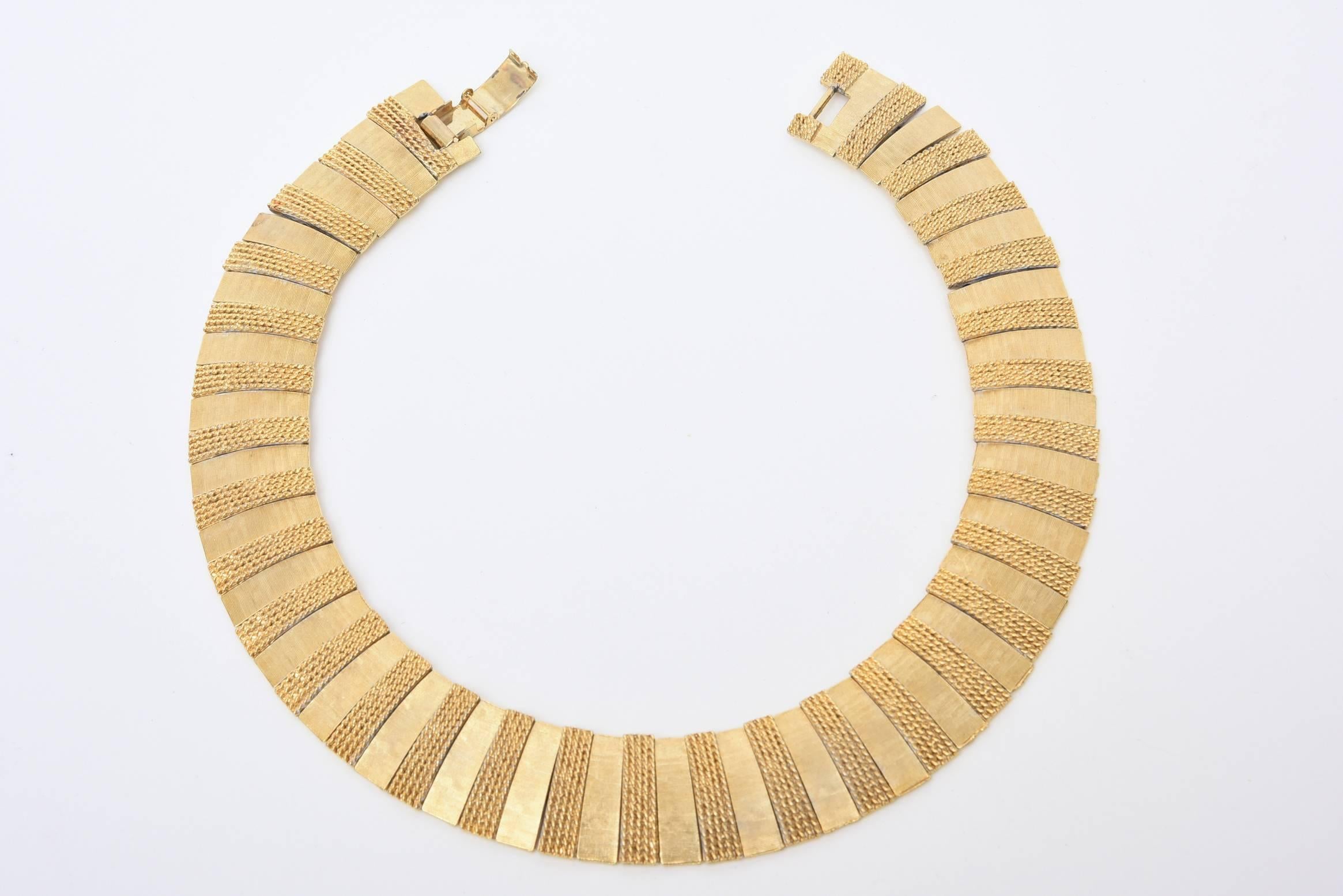 A combination of brushed and woven gold-plated bar makes this vintage collar necklace a stunner. It lays beautifully on the neck and looks like real gold. This is elegant on the neck and can go dressy or casual. This is very rich looking for