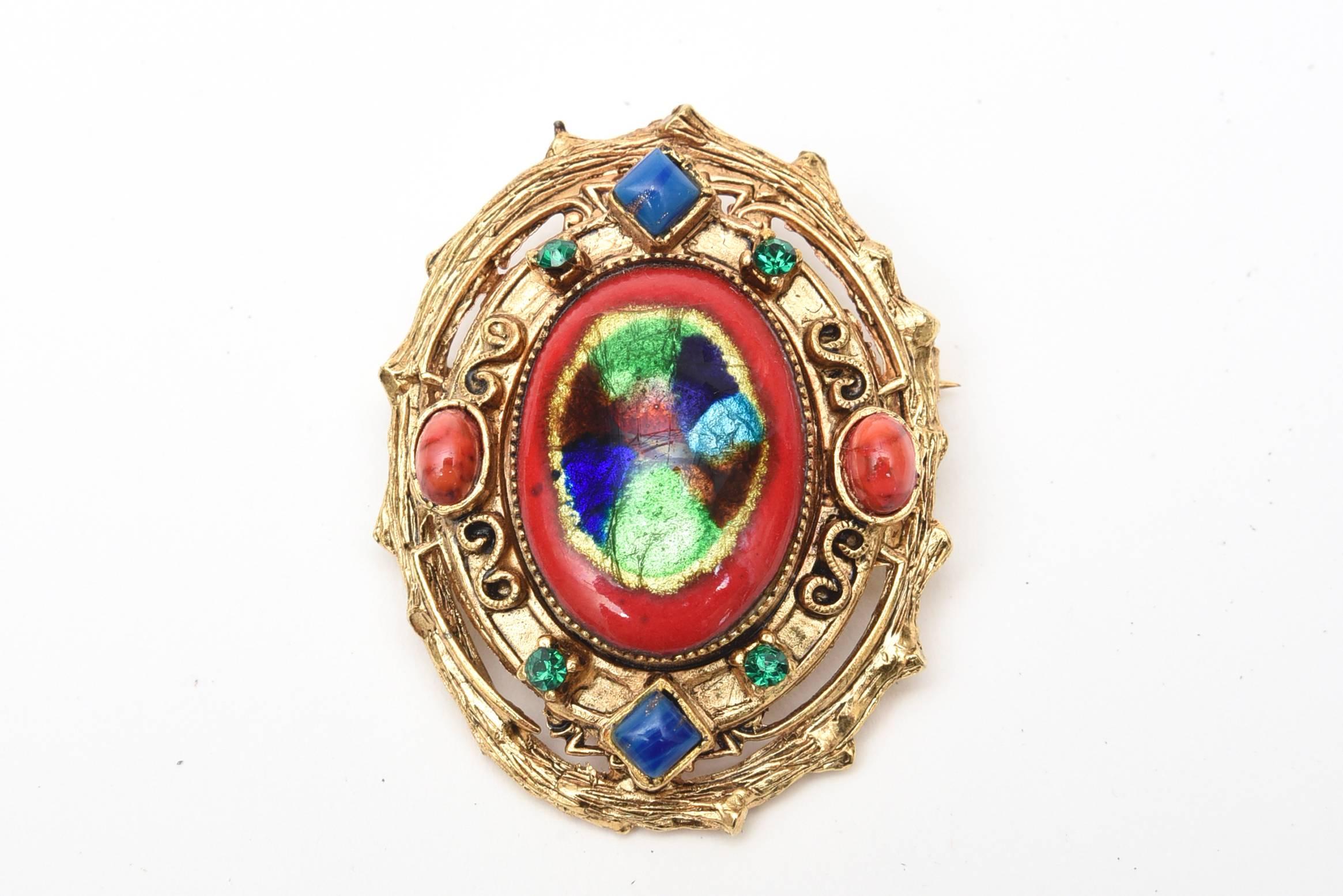 This vintage set of signed Hattie Carnegie enamel clip on earrings and small pin and or pendant is reminiscent of a bygone era of Elizabethan meets byzantine influence. The colors are rich, vibrant and exquisite as are all the details and