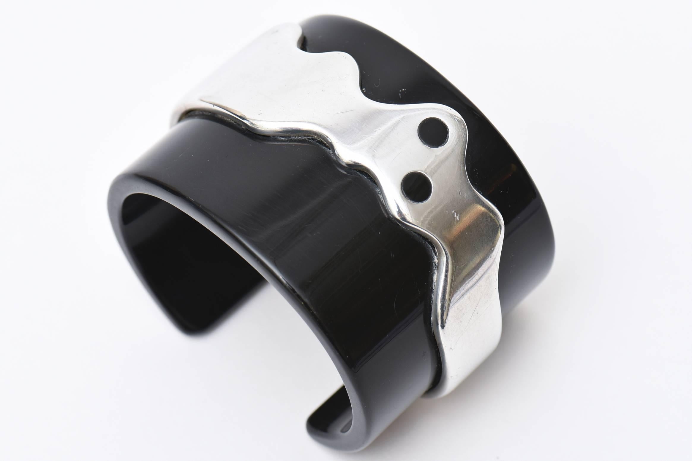 This statement chic cuff bracelet is black resin and chrome. It is French and quite modernist. A conversation piece on the wrist. The interior width is 2.25