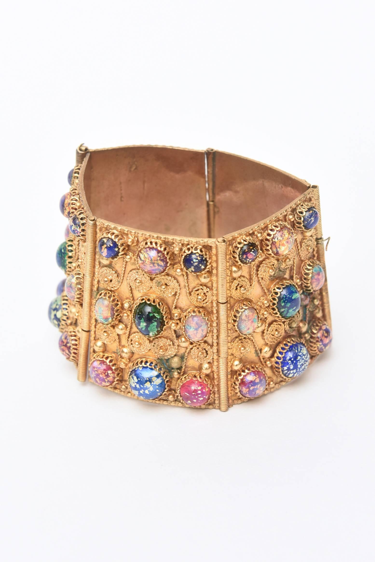 This wonderful set from the 50's is gold plated with an gorgeous array of Aurora Borealis stones set in the filigreed cuff bracelet and the bib collar necklace. This can be worn together or separately. It has an Egyptian Revival meets other worldly