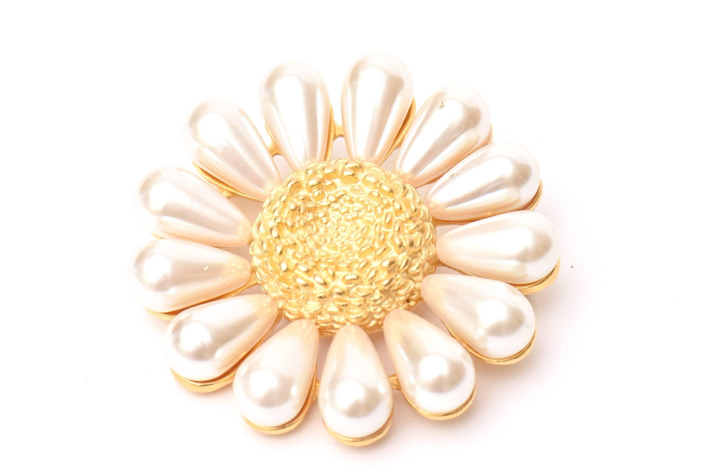 This lovely Givenchy pin is like a sunflower of faux pearls and gold plated metal. It is hallmarked 
