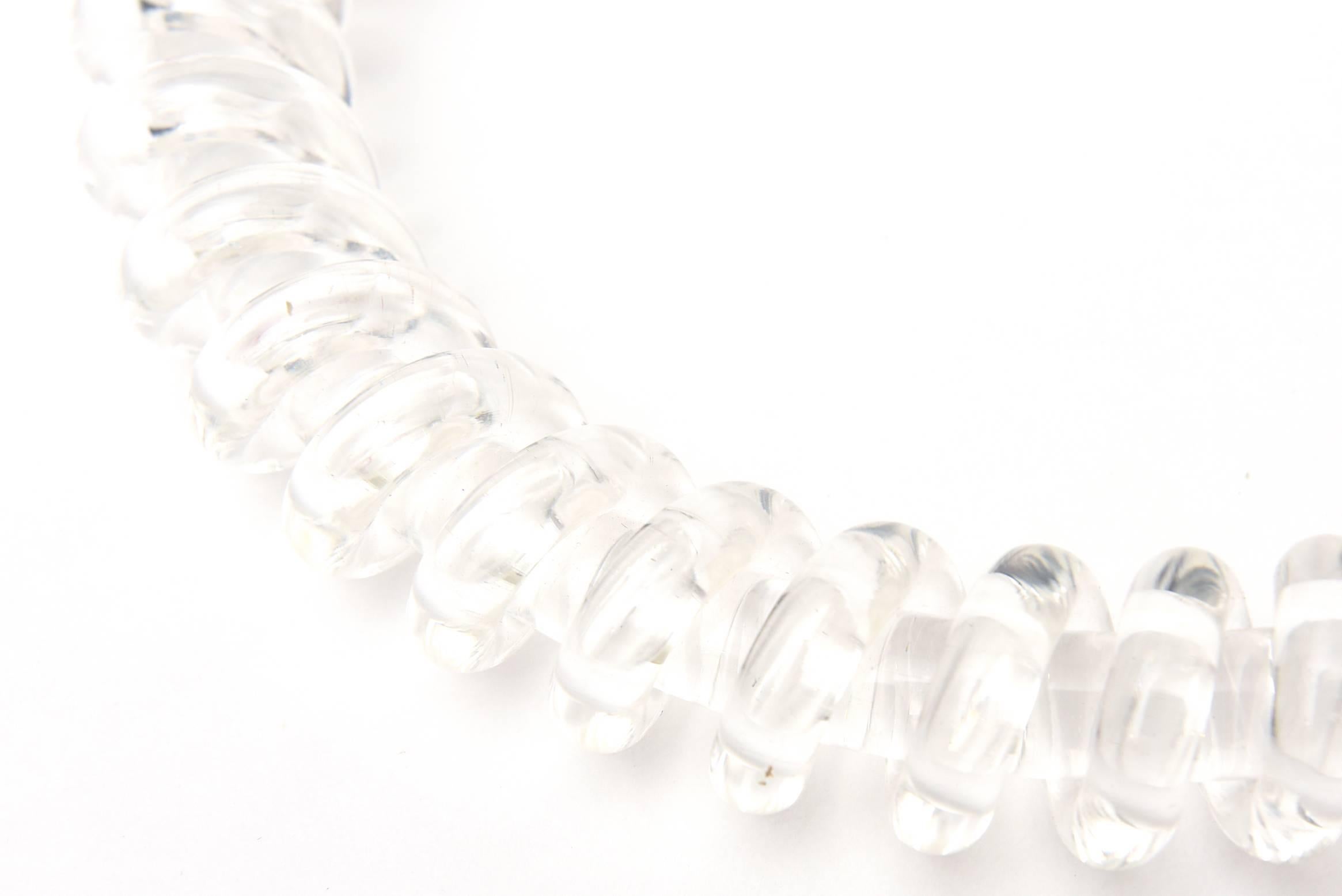 This spiral clear lucite collar necklace from the 80's is by a well known Californian artist named Judith Hendler. This is similar to her collection called telephone cord. The sculptural look of the spirals will look great against bare skin, white,