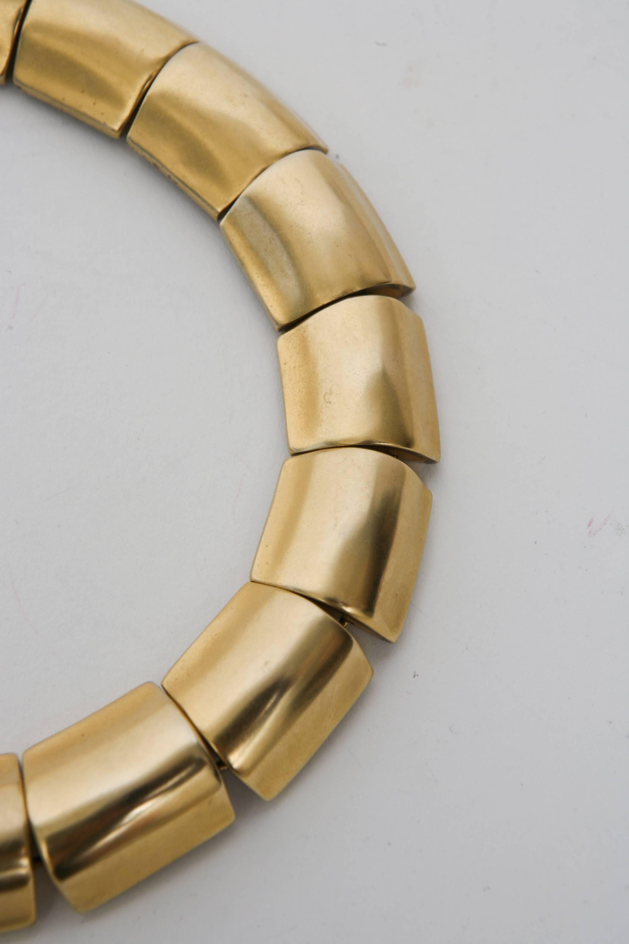 This unsigned but attributed Robert Lee Morris sculptural collar link choker necklace is stunning and timeless. It needs a small neck in order to fit. It sits high on the neck and fits tight. It is gold plated and each link is 1