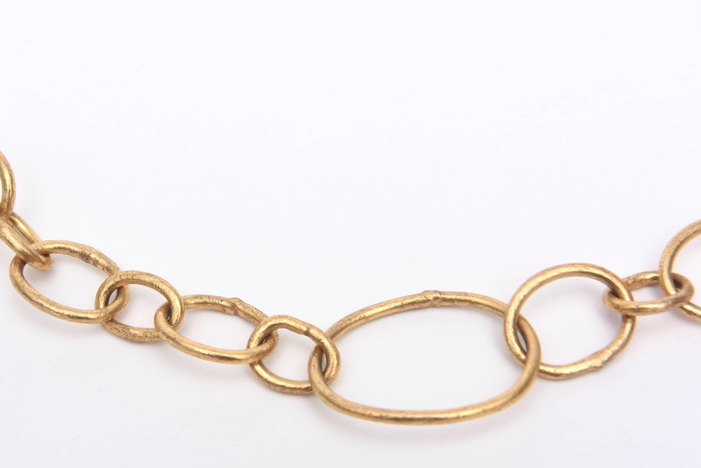The asymmetrical aspect of this signed gold filled link/chain necklace is what is unusual.The larger links are on one side and at the bottom. It is at a perfect length for any outfit. It is tagged Alexis Bittar and contemporary with a forever modern