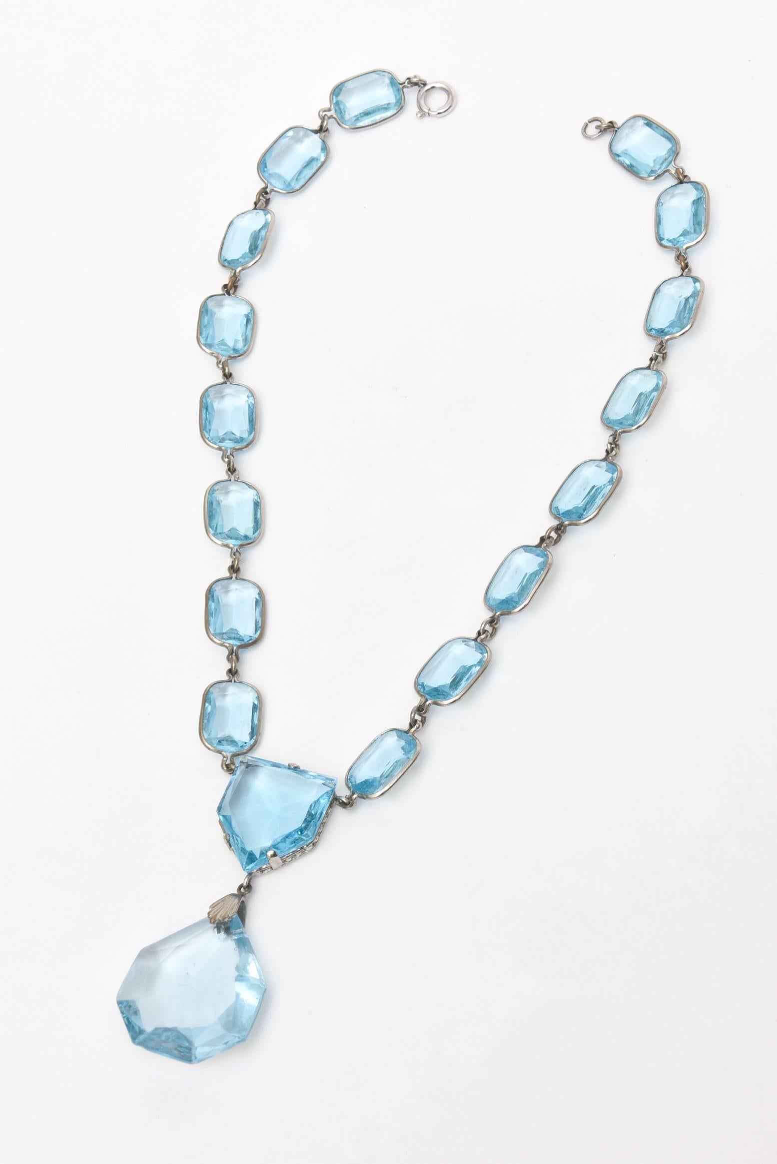 This beautiful necklace with it's ethereal luscious colored faceted glass crystals are connected with sterling silver.
It lays beautifully on the chest/neck.
The color is spectacular. Looks great on bare skin or on clothing.

Great for resort wear