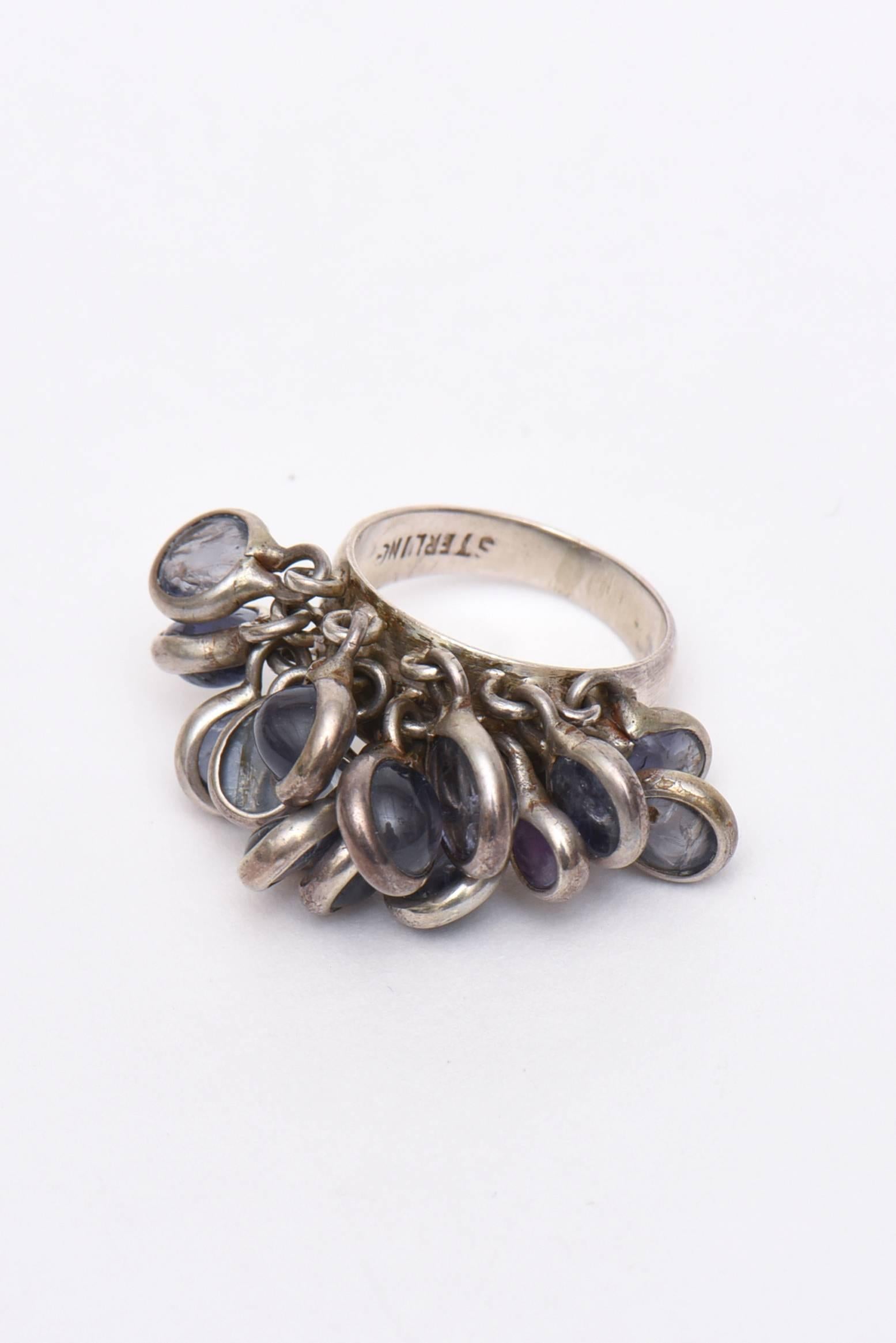 This lovely vintage ring has many disks of sterling silver and amethyst hanging from attached sterling loops. This is a wonderful sculptural ring that has movement and great eye appeal. The ring size is 5 3/4. Almost a size 6. It is marked Sterling