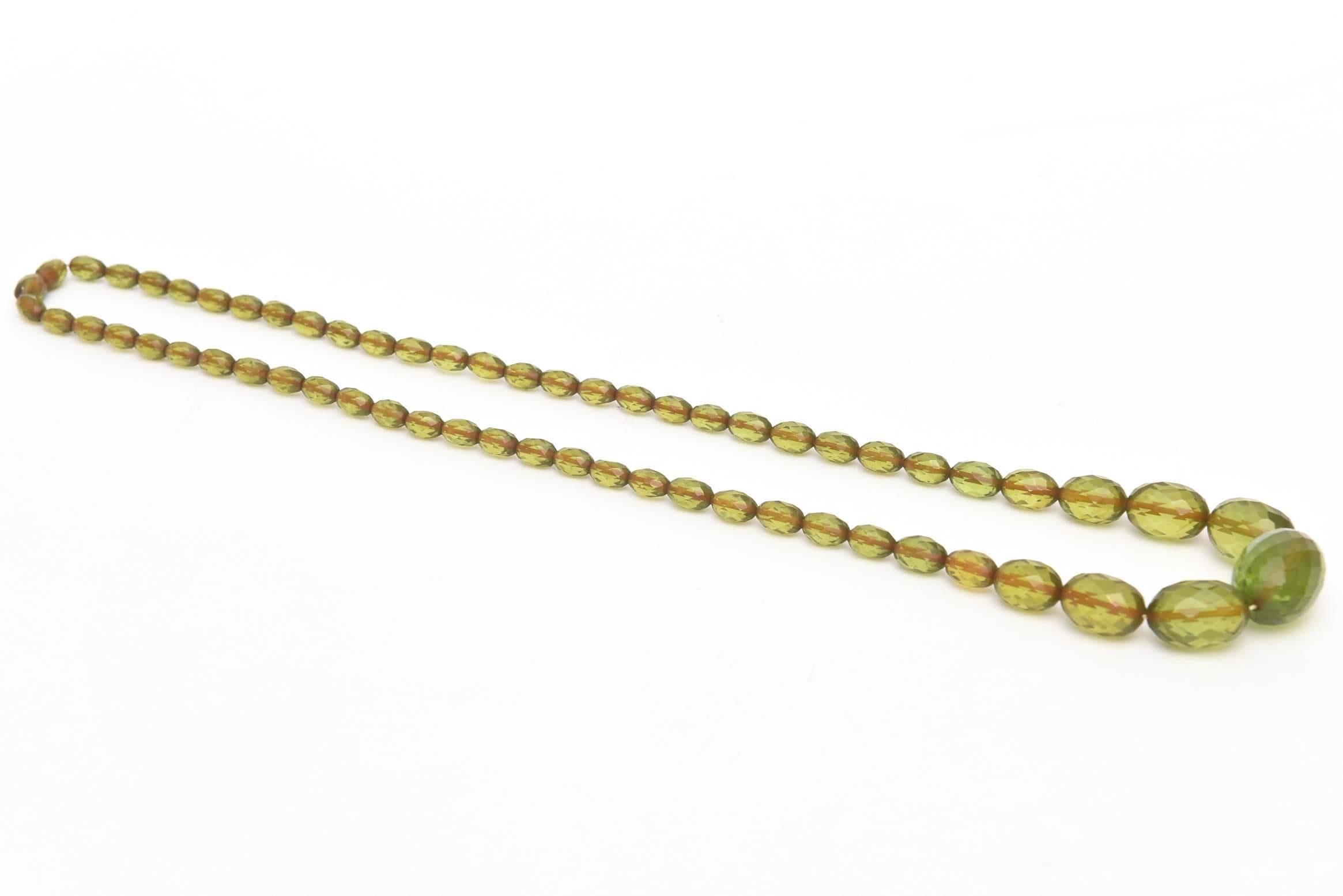 This lovely vintage one strand of luscious chartreuse green resin is diamond faceted. The cord inside is of an amber color. This is a great color for all year round and a lovely necklace. This color for fall/ winter 2023 is being shown. Green is in