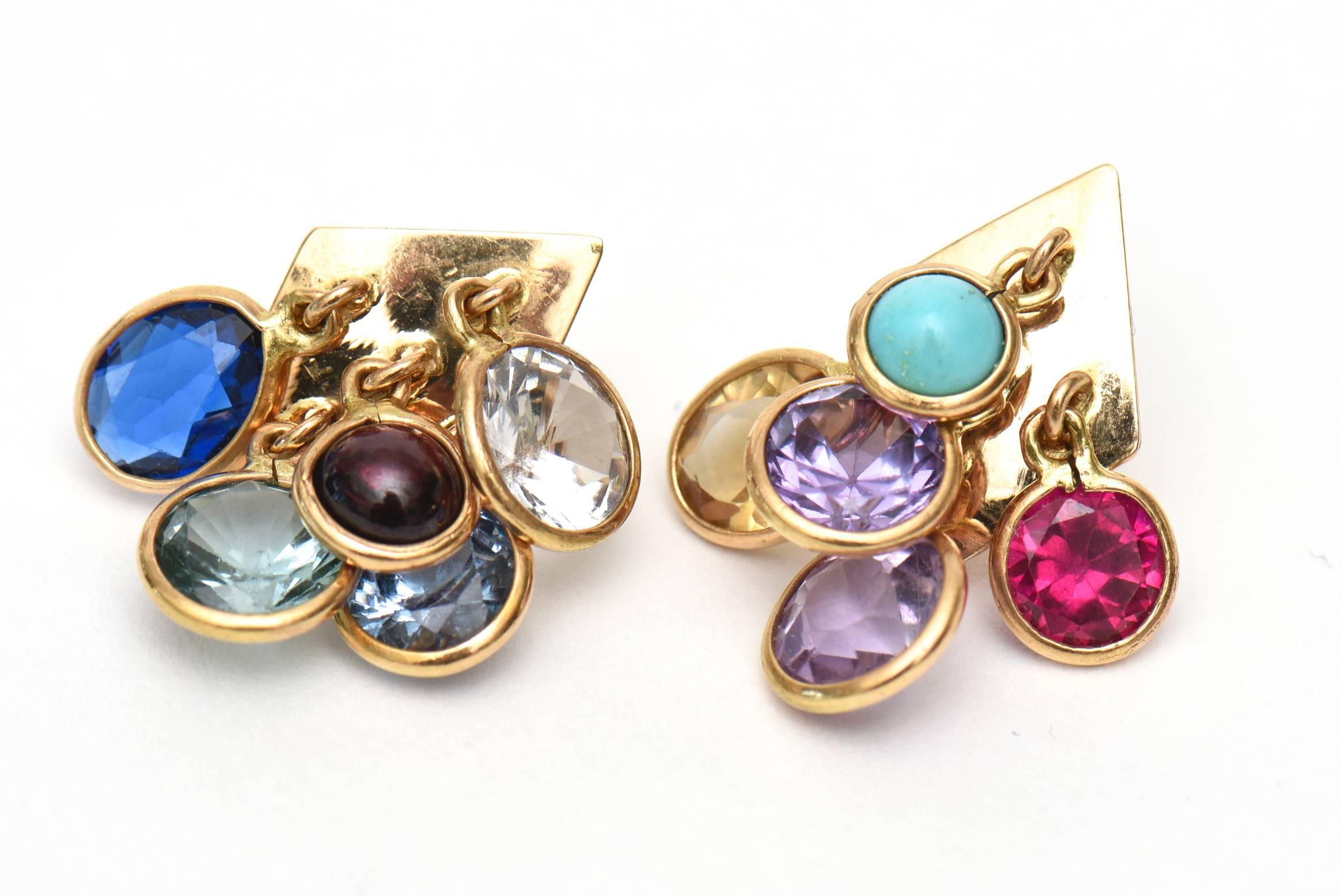 The colors are beautiful and of jewel toned hues in this set of a pair of vintage pierced earrings and  clusrter dangler ring. The stones are glass. It is metal plated for the settings. The dangle cluster pair of earrings are on the small side. This