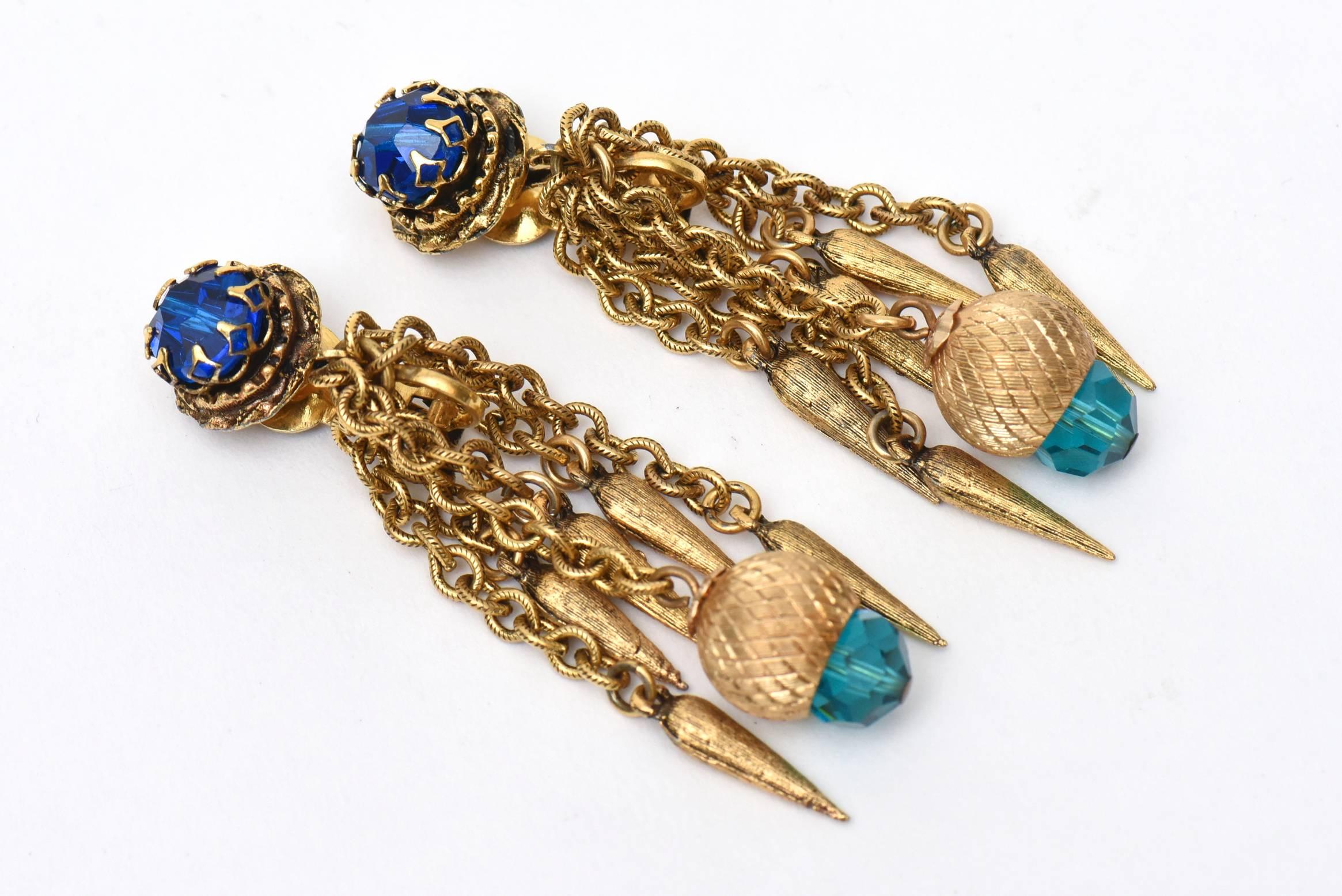 These beautiful vintage long dangle pair of vintage clip on earrings are comprised of turquoise and royal blue faceted crystal stones and chain with danglers on the tips. They look so modern today yet they are from the 60's. Tres Chic and au