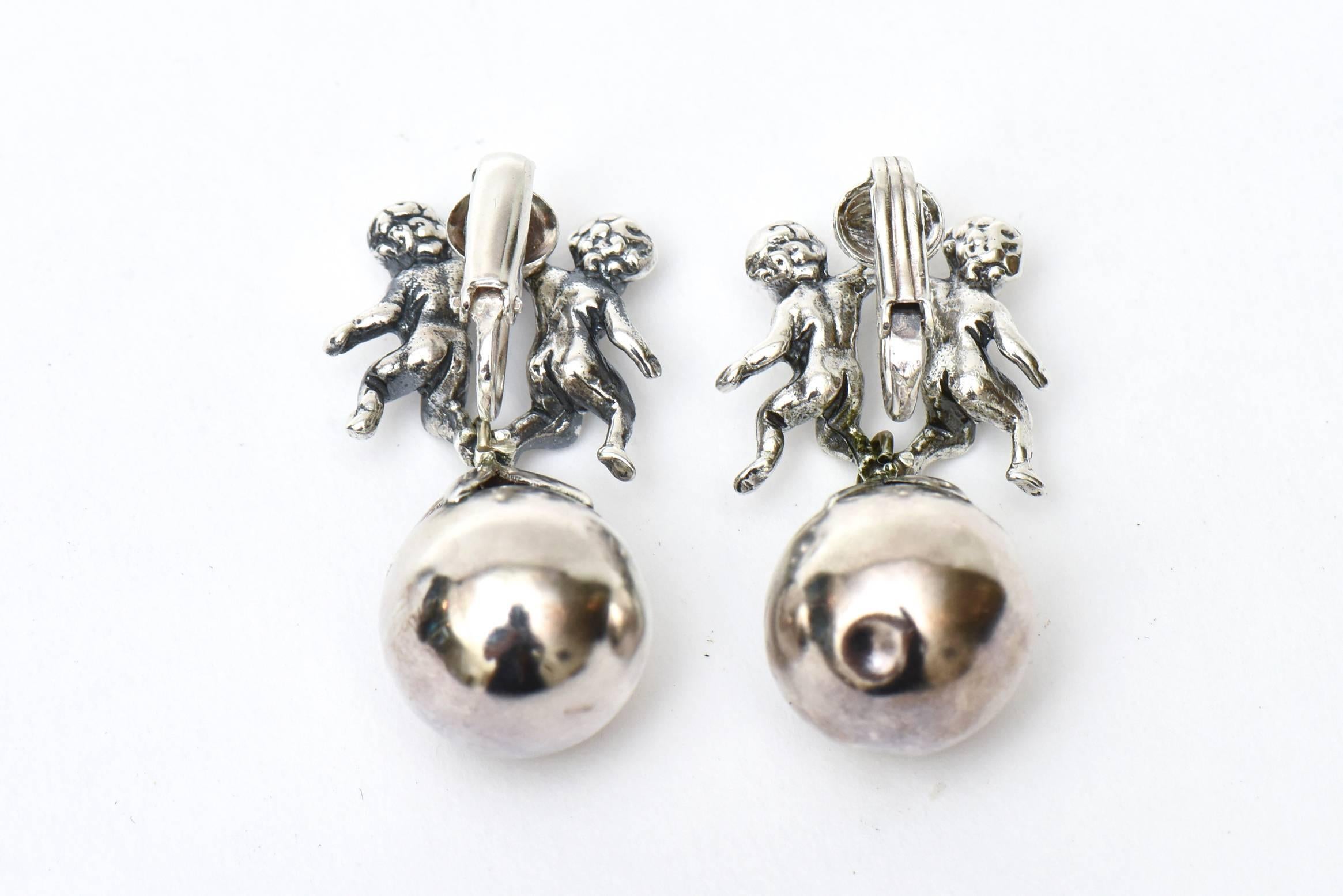 These beautiful and unusual pair of Italian sterling silver vintage mid century modern dangle drop clip on earrings are signed Cini sterling. They are wonderful on the ear  lobe. They can be dressed up or down; day to evening wear. They are from the