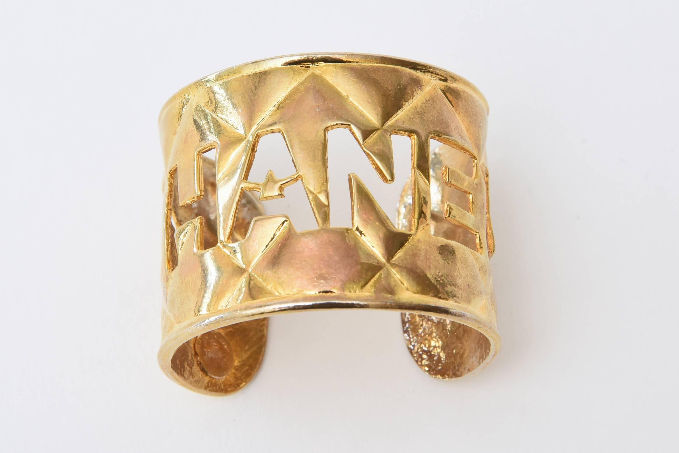 This wonderful Chanel cut out cuff bracelet is fantastic on the wrist. It is gold plated with quilted pattern and the cut out logo Chanel as the top.
It is slightly flexible and is a wide cuff. It is in very good condition.
This will fit a small