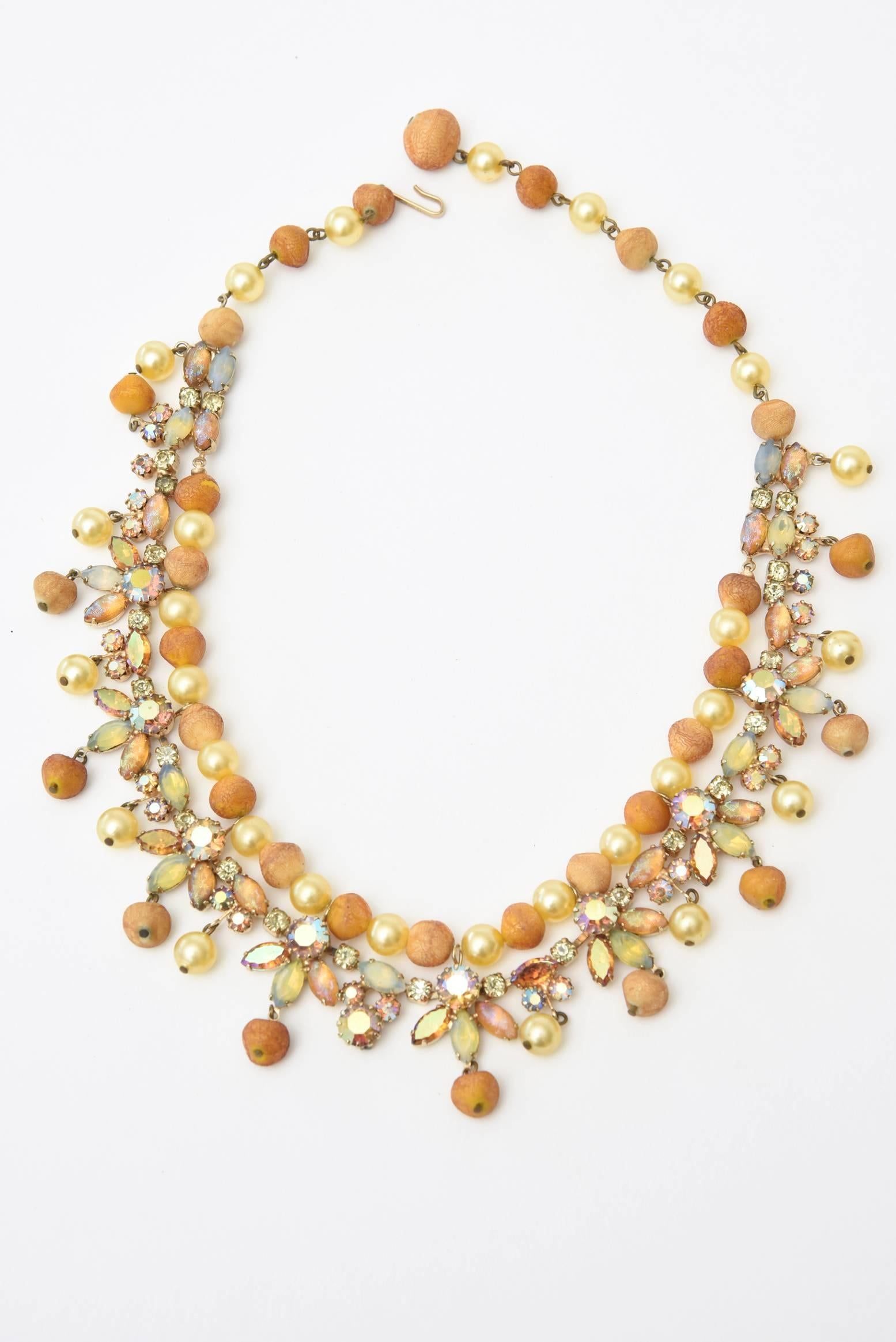 This beautiful signed vintage Kramer mid century necklace made of many color rhinestones, faux pearl, and resin is a happy piece for the coming spring summer 2020 season. The colors are a mixture of burnt orange, mustard, yellow, tan, champagne,