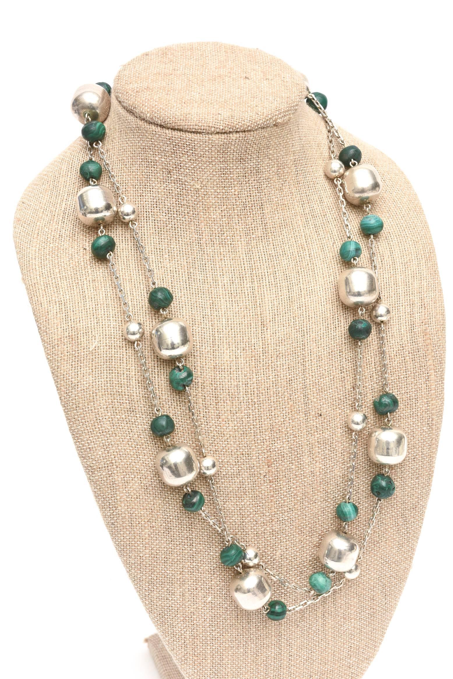 This gorgeous sterling silver and malachite strand beaded wrap necklace can be worn at different lengths when doubled or as one long dramatic strand. The sterling barrel beads are large and compliment the malachite rounded beads with an open chain