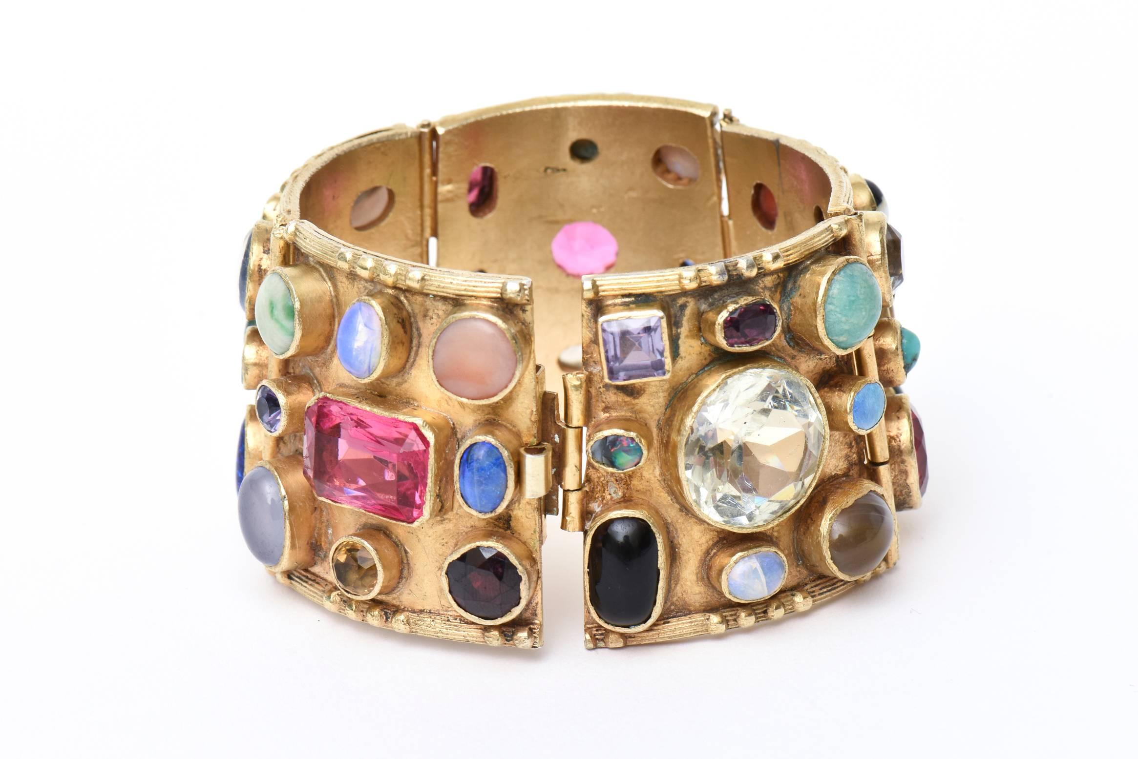 This amazing and gorgeous cuff bracelet is so arresting. It is gold plated over sterling silver with a magnificent array of semi precious stones. There is coral, turquoise, quartz, amethyst and many other semi precious stones and rhinestones and