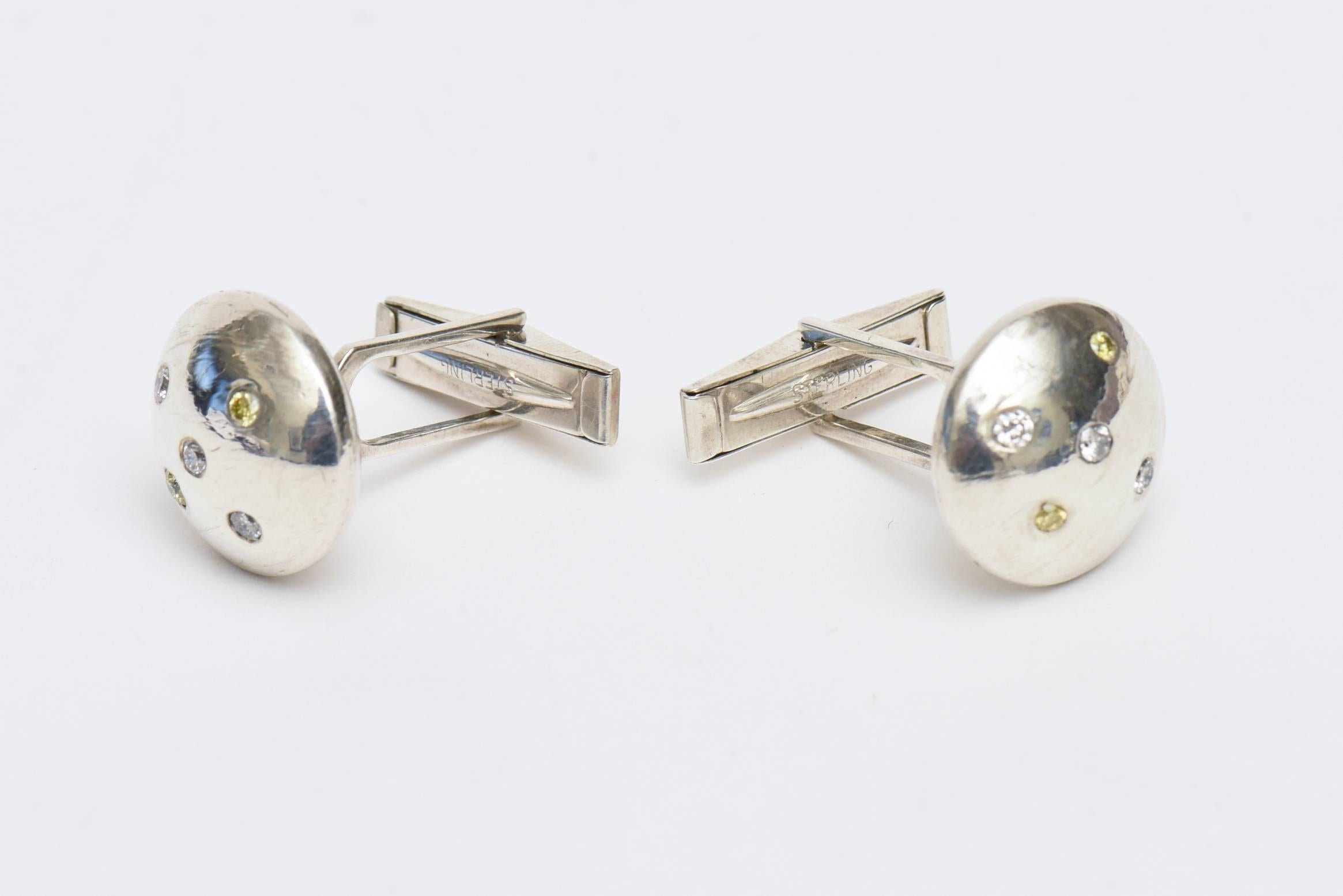 These beautiful and jeweler made sterling silver and tiny diamond cufflinks are unisex.. Their dome top has 4 small tiny diamonds in them. They are well made and have a great modern presence to them. These would make a great gift.

