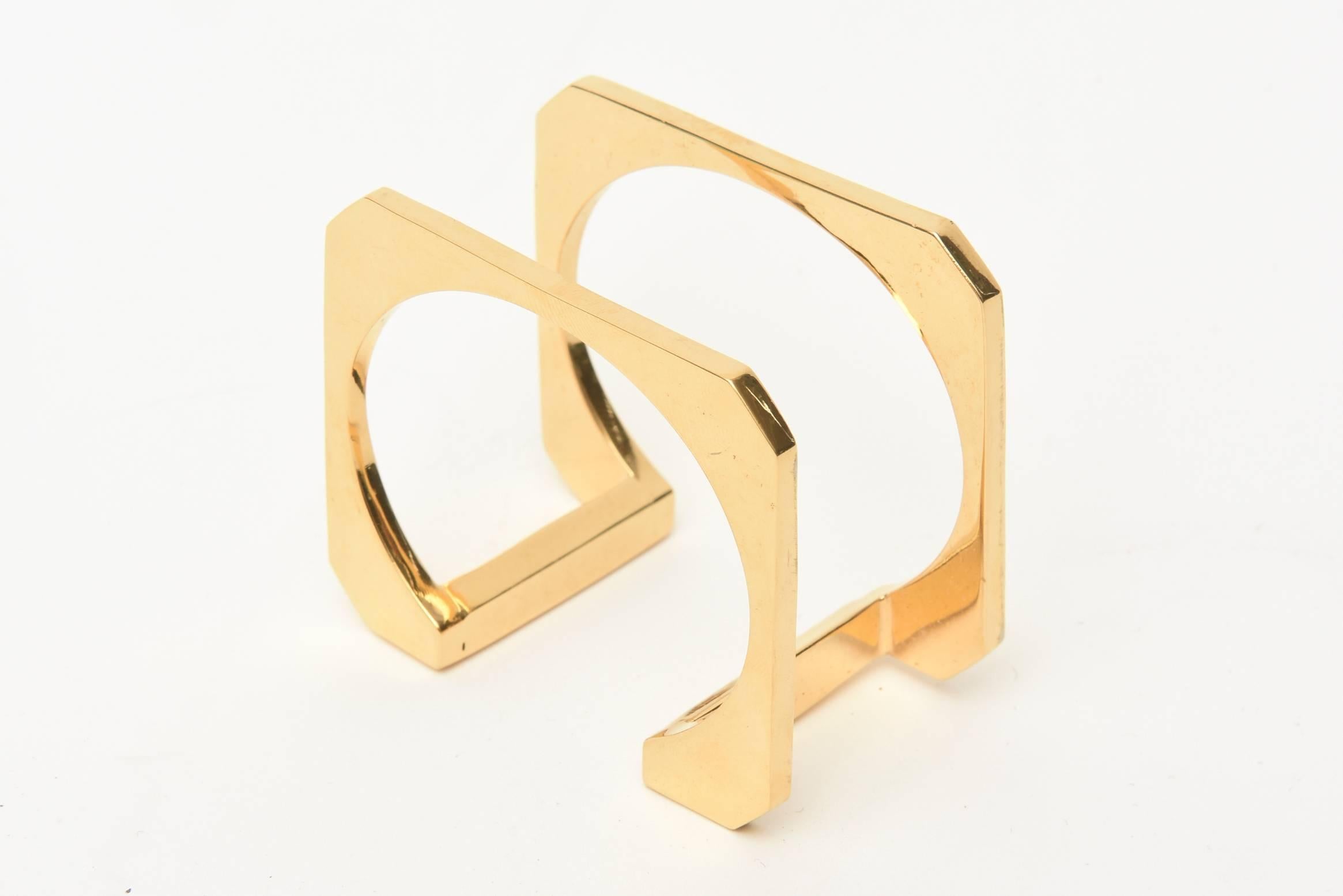 This dynamic and sculptural cuff bracelet is modernist and architectural all at the same time. It is gold plated and from the 80's. Upside down, it looks like an inverted U. It slips on the wrist and will fit a small wrist. It will only go over a