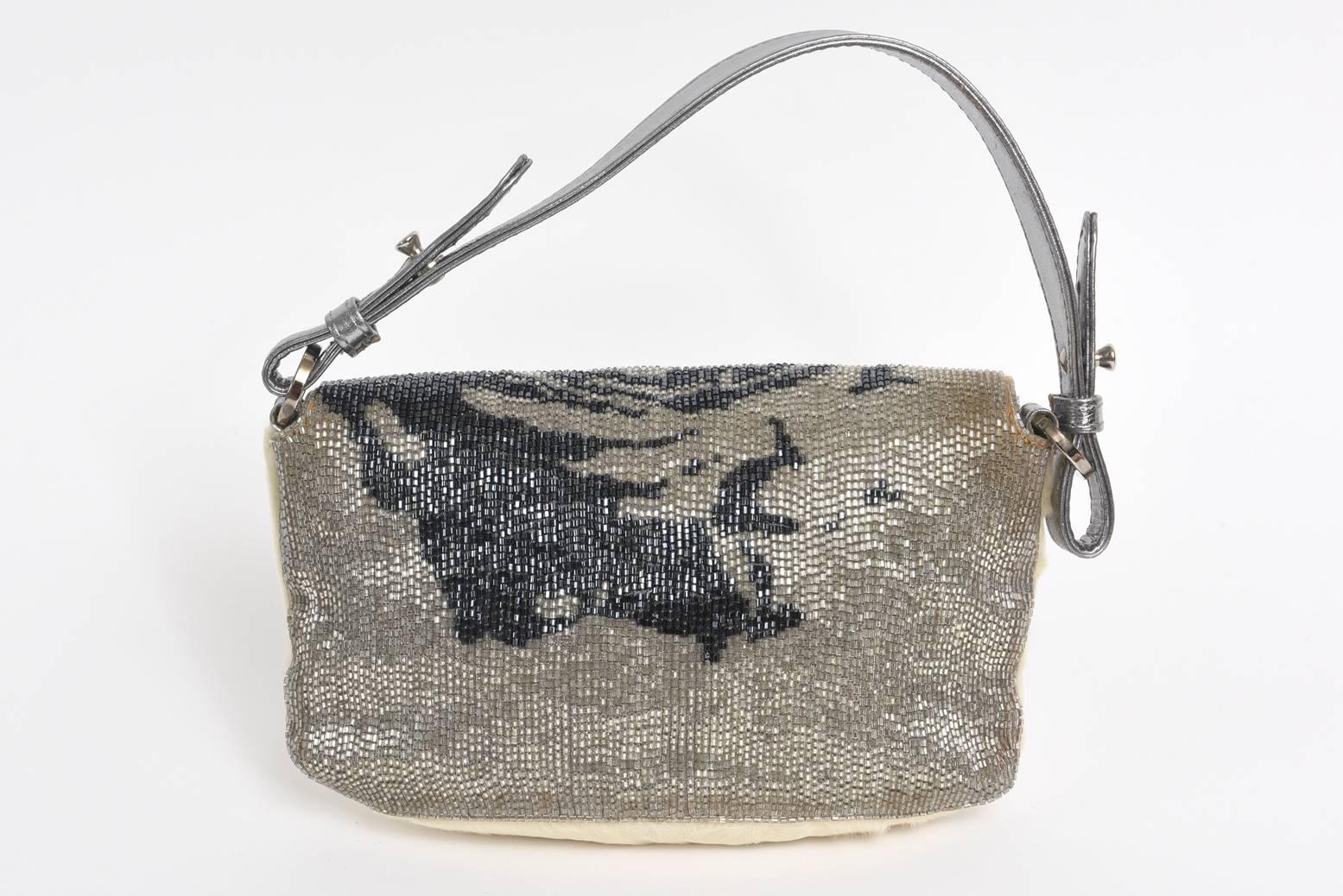 This stunning and rarely used runway limited edition Italian Valentino handbag /clutch /shoulder bag is made of the rich components of silver napa leather, white rabbit fur and Swarovski crystal beading in a grey/black and blue design. It has a