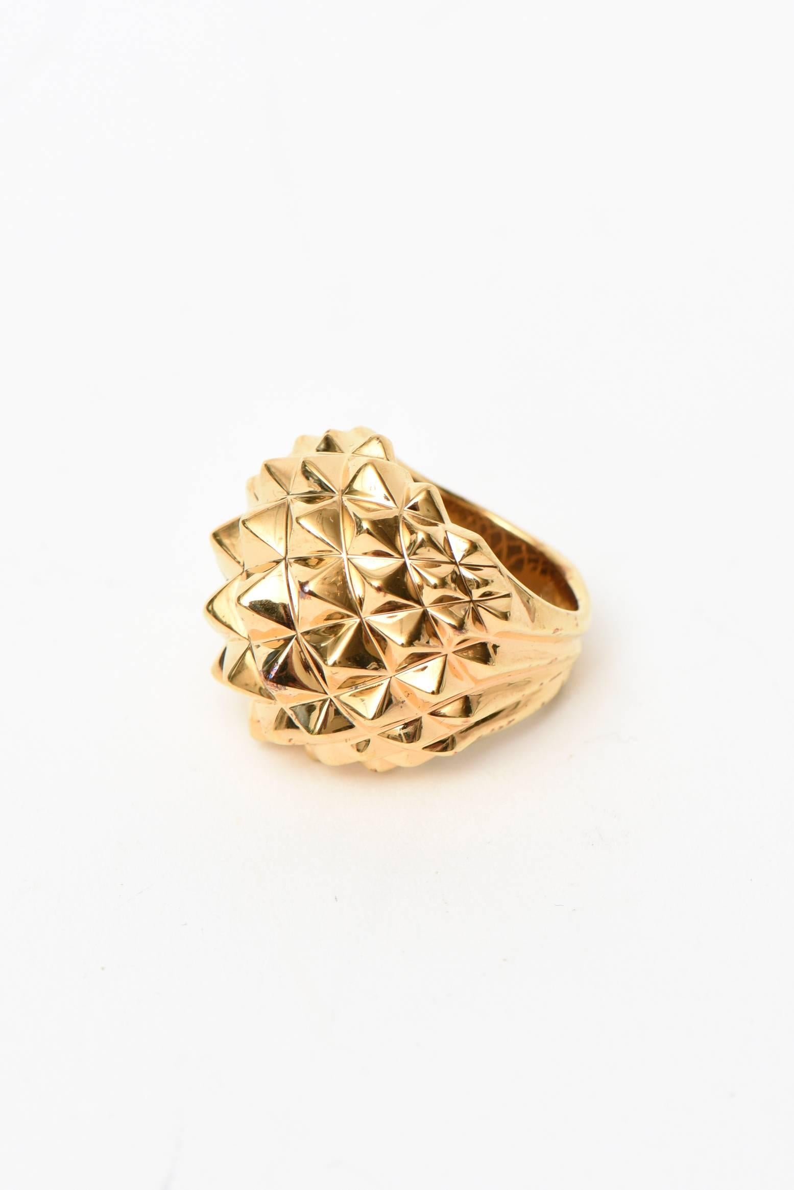 This chic and timeless edgy yet modern 18 K gold plated over sterling silver stud cocktail dome ring is by none other than the collectable and forward jewelry designer from London named Stephen Webster. His coterie of clients include famous people